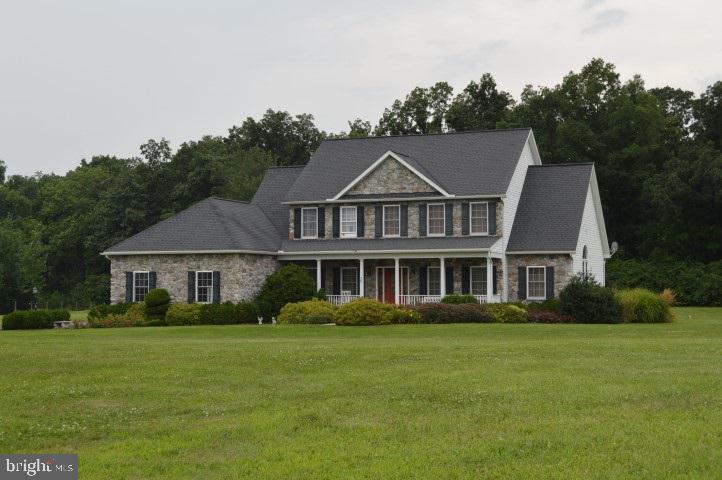 This beautiful 4 BR home sits on 11+ acres w/3200 sq. ft. of living space! Open floor plan, custom kitchen w/cherry cabinets & Corian counters, 1st floor master w/full BA & 2nd floor master w/full BA, all 4 bedrooms have W/I closets.  FM RM w/FP, wood floors, 2 car attached & 3 car detached garages.  Backs up to Quail Valley Golf Course.  Horses welcome!