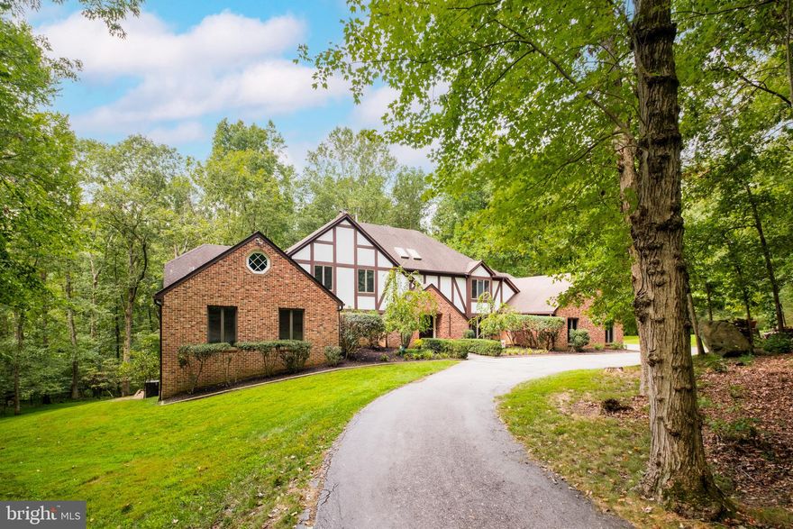 This graceful home on 4 wooded acres in Summerwind features TWO main level bedroom suites, plus four additional bedrooms and a total of 5-1/2 baths, with an estimated 7900 SF of total living space on three levels! Enjoy the country-like serenity from the huge deck, with wooded views and horse trails, but you also get the advantage of being close to great schools, convenient commuting options, and all there is to do in the northern Virginia/Washington D.C. area!
This elegantly laid-out home has a large primary bedroom suite on one end of the main level and a second bedroom with en-suite bath on the other end – perfect for multigenerational living or as a guest or nanny suite. There is so much room to entertain with the formal dining room opening into the huge kitchen/breakfast area and charming family room and flowing out from there onto the deck!
Working or schooling from home? Options abound for workspaces both large and small, from the main level sitting room/flex space, to the primary bedroom’s study with its built-in bookcases and drop-down secretary desk, as well as the upper level bonus room and the lower level rec room!
Time to take a break from work and stretch your legs? Let your imagination lead the way into the racquetball court – or maybe you prefer pickleball, basketball, fitness, or yoga! Get outdoors and enjoy the grassy level side lawn for outdoor games or a cozy fire pit area or follow the horse trails for a walk through the woods.
This wonderful Summerwind community is one of the master developer John Ringle’s equestrian gems! The private road and bridle trails are exclusive to members and guests only. Riding trails intertwine the landscape throughout this part of Fairfax Station, yet you are just minutes from great shopping and dining options; beautiful Burke Lake Park and Golf Course; the Workhouse Arts Center; the nearby regional parks of Fountainhead, Sandy Run and Occoquan; George Mason University; and the historic towns of Clifton, Occoquan and Fairfax. With quick access to I-95, Route 66, Route 123, and the Fairfax County Parkway, it’s an easy commute into DC and throughout northern Virginia. The Springfield Metro and the Burke VRE stations are close by. There is so much to look forward to when coming home to this peaceful haven, in its tranquil setting, a sweet retreat from today’s hectic lifestyle!