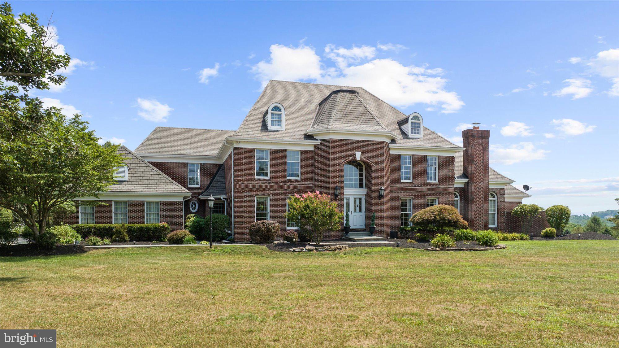 Stately All-Brick Estate with 5,185 Sq Ft of Luxury Living!
This magnificent home offers timeless elegance, craftsmanship, and breathtaking views throughout. Step into the inviting foyer with marble floors, soaring ceilings, and a stunning winding staircase that sets the tone for the grandeur within. The expansive first-floor primary suite features a cozy fireplace, private patio, two walk-in closets, and a luxurious en-suite bath with marble flooring. Entertain in the formal dining room with marble floors, or unwind in the formal living room featuring dramatic vaulted ceilings. Work in style from the exquisite cherry-paneled study. The gourmet kitchen is a chef’s dream—offering granite countertops, propane cooking, stainless steel appliances, an abundance of cabinetry, a walk-in pantry, and is open to a spectacular two-story family room with a fireplace and engineered hardwood floors. Each spacious bedroom includes its own private bath. Additional features include two staircases, a first-floor laundry/mudroom, central vacuum, and a cedar closet. Outdoors, enjoy a large stone patio, beautiful landscaping, an in-ground pool with a whirlpool, and an oversized 3-car garage. With abundant natural light, custom finishes, and impressive architectural details, this home is truly one of a kind.
Please view the video tour to fully appreciate all this stunning property has to offer.