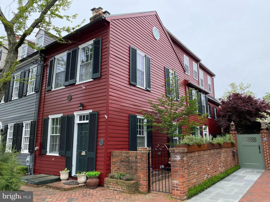 Located on one of the most picturesque streets in the heart of historic Old Town Alexandria, this charming 1826-built home seamlessly blends the elegance of the past with today’s modern amenities.  
As you enter the home, you're greeted by beautiful original hardwood floors that lead you into the colonial-style living and dining areas—perfect for intimate gatherings or quiet evenings around the hearth of the gas fireplace. The updated kitchen, combined with a cozy den with gas fireplace, is ideal for casual entertaining, with direct access to the tranquil, back garden, surrounded by brick walls with a brick patio that offers a peaceful escape right at your doorstep. Take your pick of two sets of stairs leading to the upper levels! 
On the second level, you’ll find three generously-sized bedrooms and two full baths, all updated for comfort and style. The front bedroom has built in shelves while the back bedroom enjoys its own private sitting porch—a serene spot to unwind. The other bedroom on this level is equally spacious, with plenty of room for family or guests.
The expansive primary suite, located on the 3rd floor, offers a private retreat with stunning views from a balcony that overlooks the historic rooftops and lush gardens surrounding the property. This room is filled with natural light and provides ample space for both relaxation and storage.
Plantation shutters provide privacy in LR, DR and front bedroom. Sunlight pours into the abundance of windows(24) on all 3 sides of this unique home. 
Don't miss the bonus space in the finished basement. Exposed brick and the painted coffered ceiling makes this space charming and practical. Perfect for a recreation room, workout room/gym. There is plenty of storage space with room to be creative.  
Don't miss out on the blend of historic character and contemporary updates in this rare Old Town gem.