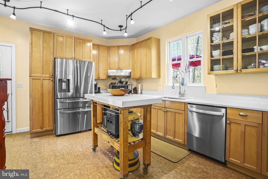 Come experience this beautiful home set on a private 1.42-acre lot in the water-privileged community of Edgewater Beach. The spacious kitchen features silestone countertops and overlooks the dining area and living room, where a cozy wood-burning fireplace creates the perfect setting for chilly evenings. A private main-level office offers a quiet retreat for work or study, and hardwood floors flow throughout the main level. Step outside to the rear deck—an ideal place to relax and enjoy nature, complete with abundant wildlife. Upstairs, the primary suite boasts a sitting area and private bath, along with two additional bedrooms, a full hall bath, and a convenient washer and dryer. The lower level includes a generous family room, a fourth bedroom (no closet), and a storage area. From here, step out to the large screened rear porch—perfect for entertaining or unwinding. This one-of-a-kind property offers privacy along with access to exceptional community amenities, including a beach pavilion, pier with boat slips, boat launch, and kayak racks. Enjoy a short stroll or bike ride to nearby shopping and more.