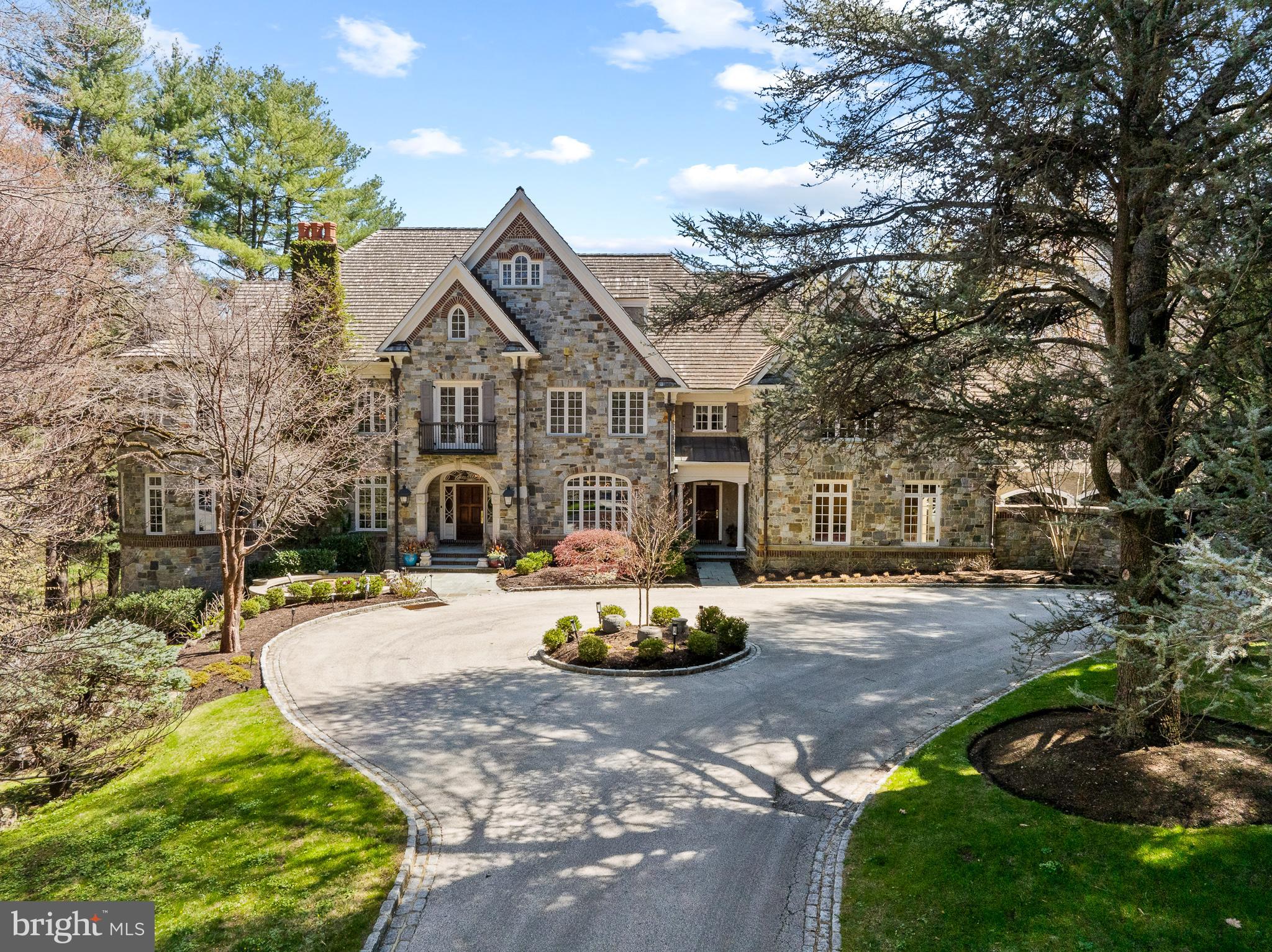 Nestled behind a gated entrance in Gladwyne’s prestigious estate section, 1045 Waverly Road is a breathtaking stone manor home crafted by renowned builder William Smith. Designed to transcend time and style, this eight-bedroom, nine full and three half-bath European-inspired estate offers over 15,000 square feet of exquisitely finished living space across four bespoke levels. 4 car oversized garage with motor courtyard.
Set on 1.5 lush, private acres just moments from the Village of Gladwyne, this home is a rare fusion of old-world craftsmanship and modern luxury. Soaring 10+ foot ceilings on the main and lower levels create a sense of grandeur, enhanced by oversized windows that flood each space with natural light.
At the heart of the home lies a spectacular chef’s kitchen with dual marble slab countertops, a double Viking range, full refrigerator and freezer, and an oversized island. This stunning space opens to a full bar nestled within the Great Room with soaring 20+ foot ceilings. Six gas fireplaces warm the living room, study, primary suite, great room, and two separate lower-level entertaining spaces.
Primary Suite offers a Sitting Room, bedroom with fireplace, private terrace, Yours & Mine Bathrooms, and closets, Dressing room along with a coffee bar.
Each additional spacious bedroom features it's own marble bathroom and walk-in closet.
The fully finished lower level is a destination of its own, with radiant heated honed marble flooring throughout. Here you will find a billiard room, family room, lounge, sauna and steam room, wine cellar and tasting room, caterer’s kitchen, home theater and Gym.
A full elevator services all levels, ensuring ease and accessibility throughout.
Outdoors you will find a bluestone patio surrounding the resort-style pool and spa, offering tranquil views of the surrounding natural beauty and mature landscaping.
This is Main Line living at its most refined — masterfully crafted, pristinely maintained, and exceptionally styled. A home that honors tradition while embracing luxury, 1045 Waverly Road is a once-in-a-generation offering.