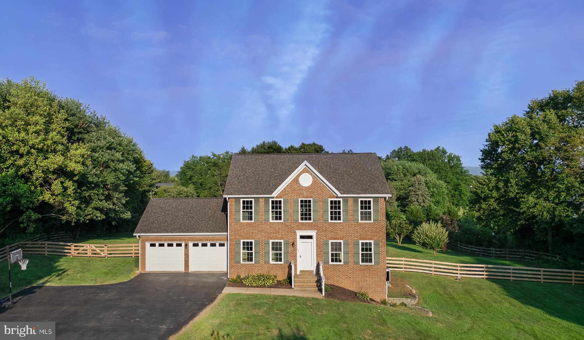 Step into this beautiful brick-front colonial home located in desirable Summit Point, WV. This well-maintained property is an excellent option for commuters. Come home to the 1.28-acre level yard featuring mature apple trees. The rear deck and patio provide an inviting outdoor living space. The ground floor includes a living room, office, half bath, generous great room, and kitchen. The well-appointed kitchen includes granite countertops, marble backsplash, stunning stainless steel appliances, Kitchenaid gas range, and a spacious island. The primary suite features an extra-large walk-in closet. The home is equipped with two new heat pumps installed in 2025, providing zoned climate control. Additional features include a paved drive and a two-car garage. This lovely property blends style, functionality, and convenience. Don't miss the opportunity to make this beautiful home your own! Professional photos will be added.