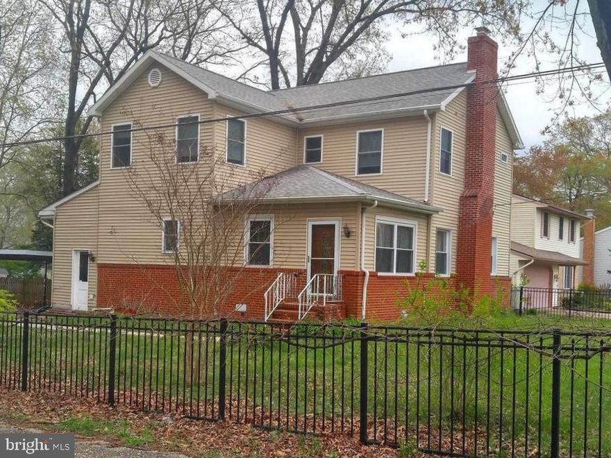 Spacious 3 BR, 4 BA home on a large corner lot with fenced yard. Features a main level bedroom and upper primary bedroom with full bathroom, dual vanity and walk-in closet. Dual zoned for efficient heating and cooling. Tankless hot water heaters means you never run out of hot water. Deck and covered carport/driveway. Bonus room upstairs could be used as office space or an additional bedroom. Wood-burning fireplace. Newer kitchen. Two laundry rooms, upstairs and in the basement. Basement area allows for plenty of storage and also has a full bathroom.  Across the street from Arundel High School and close to Ft Meade, shopping and restaurants.