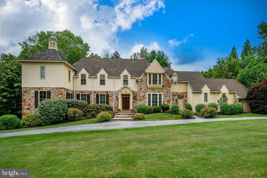 Located in the coveted community of Ravenscliff, this exquisite 5-Bedroom, 4.1-Bath home, designed by the renowned Architect Fred Bissinger, epitomizes luxury living at its finest. Built with the utmost attention to detail and loaded with extras, this residence seamlessly blends elegance, comfort, and modern amenities.
On a sprawling 1+ acre double lot, beautifully landscaped with mature plantings, this property offers a picturesque retreat within the top-rated Radnor School District. Boasting timeless architectural design, the home showcases a striking façade, expansive windows that flood the interiors with natural light, bay windows with deep sills, and meticulous craftsmanship throughout.
Spanning across generous living spaces, this home offers ample room for both relaxation and entertainment. From the welcoming foyer to the elegant living areas, each space is thoughtfully designed for comfortable living. The first-floor features 9’ and 10’ ceilings throughout adding to the expansive feel of the home.
Upon entering, you are greeted by a grand two-story Foyer with soaring ceilings and hardwood floors that flow throughout the main level. The spacious Living Room features chair rail, double crown molding, built-in bookcases, and a gas fireplace, while the adjacent Library/Office offers hardwood paneling, built-in bookcases, cabinets, and a wet bar. To the right of the Foyer is the formal Dining Room with gorgeous wainscoting, double crown molding, chandelier, decorative ceiling dome, and a door to the Kitchen.
The heart of the home is the expansive Gourmet Kitchen, complete with custom cabinetry, granite countertops, high-end appliances, including a built-in 71" wide Sub-Zero refrigerator & freezer, double ovens, cooktop and trash compactor. Whether preparing a casual meal or hosting a lavish dinner party, this Kitchen is a chef's delight. The Kitchen flows seamlessly into the Breakfast Room and Sunroom, offering panoramic views of the lush backyard.
Entertain with ease in the Family Room, featuring a soaring two-story vaulted ceiling, gas fireplace, custom wood paneling, and two sets of French doors leading to the large slate-walled Patio.  There is also a screened-in Porch with slate floor off the Family Room which has access to the Patio as well.
Just off the Kitchen is a convenient Powder Room, and Laundry Room with outside entrance, built-in cabinets, sink, counter space for folding & a laundry chute. The attached 3-Car Garage has automatic door openers and plenty of room for storage.
Upstairs, the Primary Bedroom Suite is a serene oasis, featuring built-in bookcases, two large walk-in closets with custom storage, and a spa-like ensuite Bathroom. Three additional Bedrooms, two hall Bathrooms, and two extra-large storage closets in the hallway (one cedar lined) offer ample storage.  Added features are two balconies overlooking the Family Room and walk-up stairs to the Attic.
The finished Basement boasts an entertainment area with walk-out French doors to a slate Patio, hallway to Full Bathroom, door to exterior and storage room with single sink vanity. Additional features include dual-zone heating and air-conditioning, a security system, 2 sump pumps, French drain, 2 gas hot water heaters (2024), and a Generac generator for backup power for the essential components of the home.
Step outside to discover the expansive outdoor patio, featuring covered seating, a built-in Wolf gas grill, and a bluestone patio for dining al fresco. With its tranquil setting, luxurious amenities, and convenient location near downtown Wayne, you can enjoy fine dining and shopping, and access to major highways offering an easy commute to Center City Philadelphia and the Philadelphia International Airport. This property offers the ultimate blend of convenience, comfortable living, and luxurious amenities in the highly sought-after community of Ravenscliff.   Schedule your private tour today and experience luxury living at its finest.