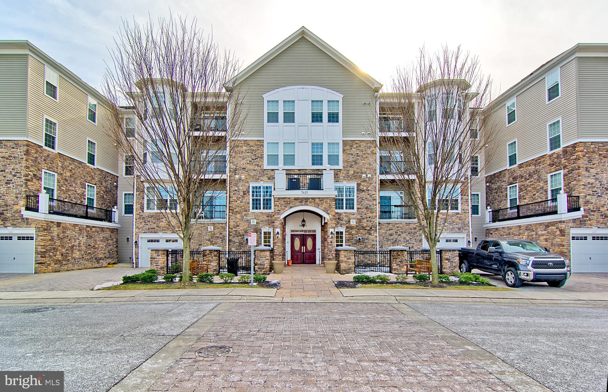 Welcome to Upscale community of Quarry Lake, 40 ac Lakeside Community in Baltimore County that features premier shopping and dining options, high-end salons, medical offices, Starbucks..., amazing Clubhouse with Gym, Sauna, Meeting and Party Rooms, Pool, Tennis... Through the Security Gates you enter the Highlands Condominiums. 7601 Travertine Dr. is located at the very end, the last court - the newest in this development. Beautiful Upgraded Second Floor Condo with Balcony, 2 Br., 2 Bth. and a Den or Office, in Model Condition, in Secure Building with Elevator, with oversized Garage. Beautiful Lake View from Living Room Balcony and both Bedrooms. Upgraded 42" Cherry Wood Kitchen Cabinets with Granite tops, Stainless steel Appliances. 9' and Coffered Ceilings. Wood Floors in Living/Dining Rooms and Den. Large Master Bedroom with Seating Room... Walk-in Closets in both Bedrooms. Gas Heat and Cooking... A Great Place to call HOME!