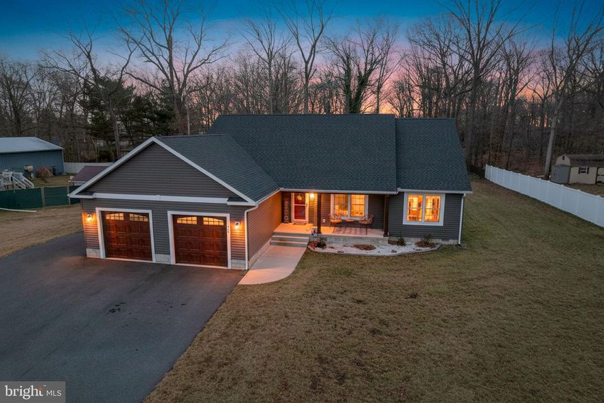 RARE opportunity to own this beautiful, 3-year-young custom, single-level home with NO HOA, located in the established Woods Haven community just off Route 1 in Milford. This Energy Star–efficient home features blown-in insulation throughout, resulting in low utility costs with electric as the only utility bill. A private well and septic further help keep monthly expenses minimal.
A generously sized covered front porch welcomes you inside to an open floor plan with modern, light-colored wide-plank premium laminate flooring throughout the home, with tile in the bathrooms and laundry room. The spacious kitchen is perfect for cooking and entertaining, offering granite countertops, an oversized island, and like-new stainless steel appliances that seamlessly flow into the dining area and living room. The home features an abundance of recessed lighting, ceiling fans in every room, and a whole-house sound system for comfort and convenience. The primary suite includes a beautiful tiled walk-in shower and a walk-in closet with a custom organization system. The two secondary bedrooms are generously sized, with one featuring reinforced flooring, previously used as a home gym. An oversized two-car garage with upgraded garage doors provides plenty of storage and additional functionality. A sliding glass door leads to the backyard, offering a blank canvas ready for the new owner’s vision.Don’t wait on new construction—this move-in-ready home already includes all the upgrades you’re looking for!