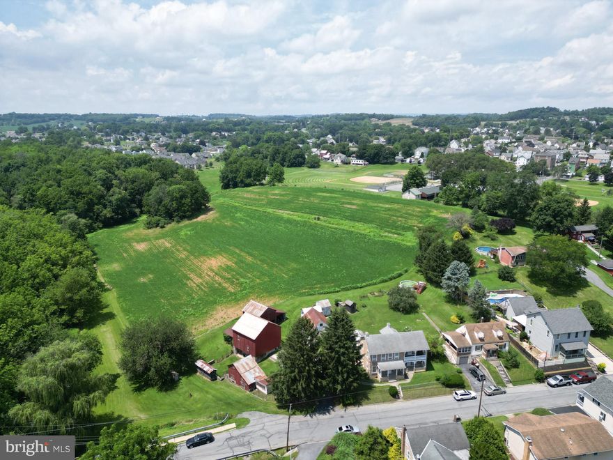 Welcome to 4181 Bridge Street in Whitehall Township! This beautiful and unique 8-acre farm has tons of potential! One possibility is a build-out/subdivision for residential homes. The property has access to public water/public sewer. This property also includes a Victorian-style home divided into 2 Units. The first unit includes 1 bedroom and full bathroom on the 1st floor and 2nd bedroom on the upper level. The 2nd unit has a 2 bedroom and bathroom on the 2nd floor.  The property also includes a large Barn, 2 summer kitchens, and multiple outbuildings.  The property backs into the Ironton Rail Trail (IRT), only minutes to Rt 145 (MacArthur Rd) and Rt 22. This is a must-see property! Schedule your showing today!