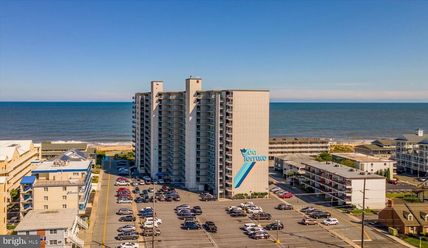 Large, direct oceanfront unit in Sea Terrace!  High and above the rest on the 12th floor, with breathtaking views of the ocean and bay!!  Very large balcony overlooking the pool, beach and ocean.  Spacious unit with over 1,200 square feet of living space.  Larger bedroom with queen bed and closet, separate full bath.  Second bedroom has two full beds, closet and full bathroom.  Living spaces include front living room, galley kitchen with large breakfast bar, dining area and oceanfront living room. Brand new stacked washer and dryer in unit! Unit has convenient storage locker on the first floor for beach chairs, etc.  Well maintained, well-managed building, office staff in lobby, two elevators, outdoor pool, tennis court, large oceanfront deck complete with tables & umbrellas.  Walking distance to several great restaurants.  This unit has been a cash cow, with excellent rental history, high rents and longer than normal rental season.  Would also make a great year-round residence.  Unit is in excellent condition, but the owner has requested to sell as-is.  Condo building has upcoming special assessment and the seller will pay that in-full at the time of settlement.