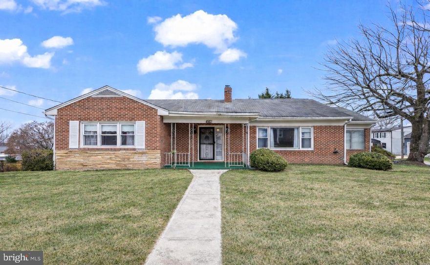 This move-in-ready, all-brick rambler offers 3 bedrooms/ 2 bathrooms, a huge unfinished basement, and a detached garage! Step into a spacious living room centered by a cozy wood-burning fireplace, flowing seamlessly into a bright sunroom!  Throughout the home, you'll find solid hardwood floors, and in the kitchen, new stainless steel appliances. The expansive, unfinished basement offers massive potential, already equipped with a second wood-burning fireplace and rough-in plumbing for a future bathroom. Situated on a large corner lot with a detached 2-car garage, you are just steps away from local shops, restaurants, marinas, and the beach. Experience the ultimate Bay-side lifestyle!