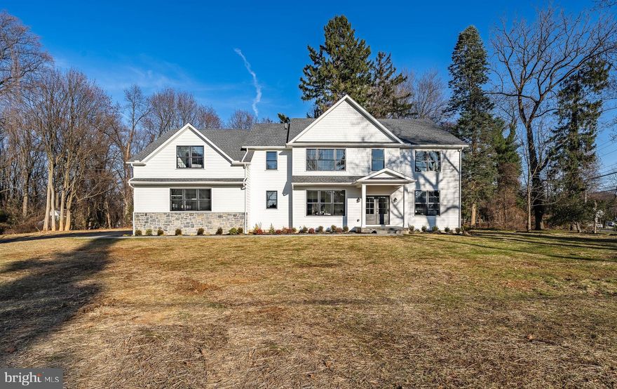 Welcome to the epitome of luxury living on the Main Line – an exquisite newly constructed home crafted by Rudloff Custom Builders, a premier custom builder where impeccable construction meets thoughtful design.  Nestled in the heart of this prestigious community, this residence boasts over 5,000 square feet of opulent finished living space on a sprawling one-acre lot. The attention to detail is evident from the moment you approach the covered front entrance, where a slate walkway welcomes you into this home. 
As you step through the double front doors into the grand entry foyer, you are greeted by White Oak hardwood flooring that seamlessly flows throughout the first floor.  The formal dining room is a masterpiece of design, featuring triple windows that fill the room with natural light, ¾ height wainscoting, crown molding, recessed lighting, a timeless lighting fixture, and built-in storage. 
The heart of this home is undoubtedly the chef’s kitchen, a culinary masterpiece equipped with top-of-the-line appliances.  The Zline 6-burner gas range with a custom vent hood takes center stage, complemented by a GE Profile microwave and dishwasher.  The open kitchen also features undercounter lighting, an 8-foot island providing lots of seating,  Quartz countertops, custom tile backsplash, a coffee bar with built in cabinets, a wine fridge, and a walk-in pantry.  A butler’s pantry with custom built-ins and open shelving adds a touch of elegance for ease of entertaining.
Adjacent to the kitchen, the great room is a warm and inviting space, anchored by a gas fireplace with a marble surround.  Custom millwork and shiplap accent wall add to the charm, while a triple window bathes the room in natural light.   The light filled morning room which flows from the kitchen, is a tranquil space where you can enjoy informal dining.  There is also an outside entrance that leads to a slate patio, perfect for alfresco meals!
For the busy household, a large mudroom off the 3-car garage is a functional “must-have”.  With loads of built-in cabinetry, seating, and an easy-to-maintain tile floor, this mudroom will certainly be worth it’s weight in gold.  
The first-floor executive office is a haven of productivity, featuring built-in cabinetry, a shiplap accent wall, French doors for privacy, and ample lighting.  Don’t miss the formal powder room conveniently located for visitors and guests!
Moving to the second floor, the primary suite is a sanctuary of luxury, featuring a coffered ceiling, crown molding, recessed lighting, and hardwood floors.  The large walk-in closet features custom built-in drawers and shelves.  The spa-like primary bath is a retreat in itself with a freestanding soaking tub, a large custom tile shower, a double sink vanity with Quartz countertop, loads of storage and a beautiful tile floor. There is also a large linen closet in the primary bath.
The second bedroom has a walk-in closet with shelving, an attached full bath with tub shower, tile floor and Quartz countertop on the vanity.  Bedrooms 3 and 4 are spacious retreats with carpeting, ample closet space and shared, well-appointed bathroom.
A versatile bonus room OR 5th bedroom offers a multi-purpose space with an alcove for a second office, two large storage closets, and plumbing already in place for a bathroom if needed.  This space could also be used as a game room, a TV room, a playroom, craft room, or an au pair suite -- the uses are only limited by one’s imagination.  The laundry room is conveniently located on the second floor.
Enter the basement through a beautiful glass door, revealing a massive space with 9-foot ceilings and an egress window – ready for your finishing touch!
This home is not just a residence, it’s a masterpiece of design and craftsmanship, offering the ultimate of luxury living in the heart of the Main Line.