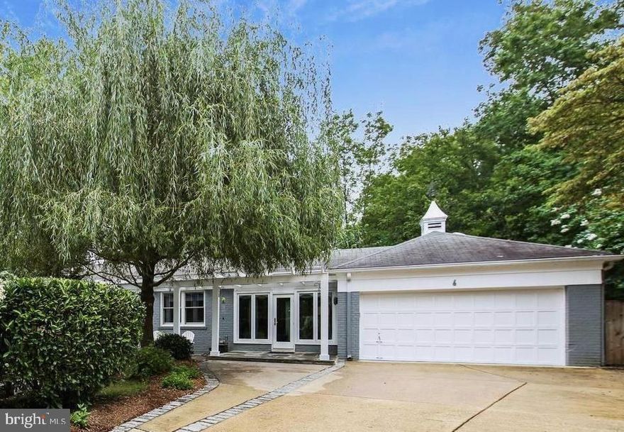 NEW ON MARKET! Tucked away at the end of a quiet cul-de-sac, this exceptional Spring Hill Court home perfectly blends sophistication, comfort, and convenience. Set on nearly half an acre in sought-after Chevy Chase, it combines the ease of city living with the serenity of a private retreat.
A welcoming foyer opens to a spacious living room with striking fireplace, flowing seamlessly into the dining room with French doors to the patio. Hardwood floors, recessed lighting, and refined finishes create a cohesive warmth and elegance throughout the main level.

The chef’s kitchen features restaurant-grade appliances, a cozy fireplace, and an open layout connecting the breakfast area and casual entertaining space, with direct access to the attached two-car garage.

The primary suite at the end of the hall includes a beautifully appointed Porcelanosa bath and thoughtfully designed closets, while two additional bedrooms share a stylish hall bath with a skylight and designer finishes.

The walk-out lower level adds incredible flexibility with two legal bedrooms, a full bath, a large family room featuring a dramatic fireplace and a large recreation space. Space and plumbing ready for a wet bar or kitchenette adds even more potential. Completing the level is a large laundry room with access to the deck.Outside, enjoy an expansive multi-tiered deck overlooking lush, landscaped grounds, your own serene escape in the heart of Chevy Chase.

Just moments from Metro, downtown Bethesda, NIH, Chevy Chase Lake, Rock Creek Park, and the North Chevy Chase Swim Club, this home seamlessly combines modern updates, timeless design, and a beloved neighborhood setting.