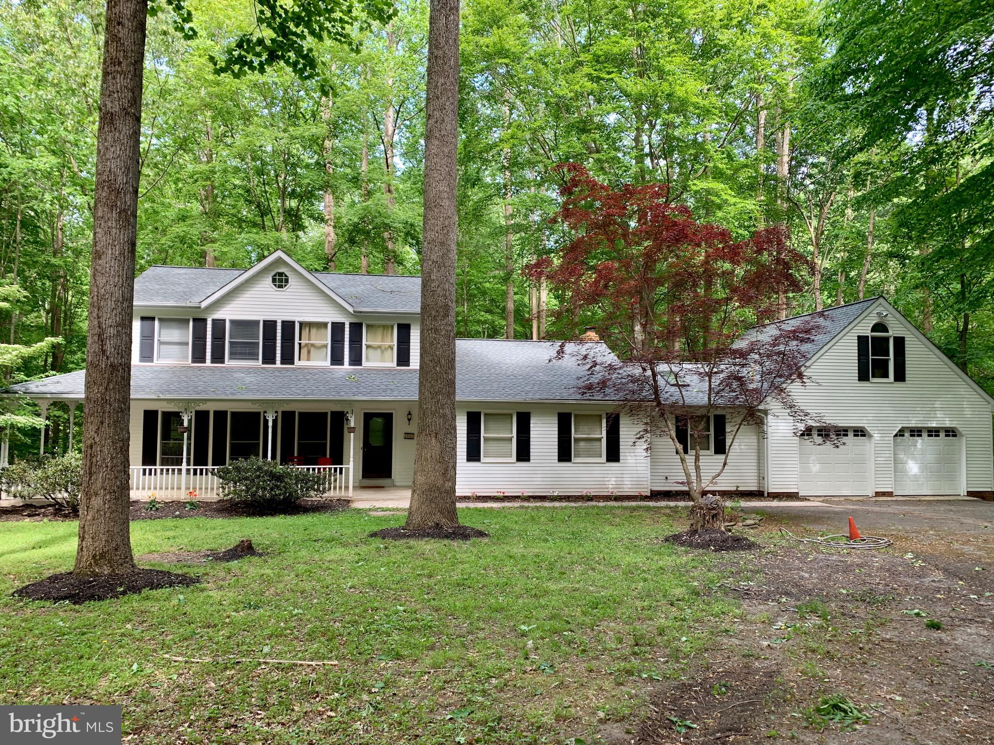 Spacious home on private wooded lot of over 5 acres. The home is freshly painted with new carpeting throughout. The main level features 1 of 2 master bedrooms with a luxury bathroom, a separate dining room and formal living room. The kitchen opens to the family room with a brick mantle and wood stove. Upstairs find an additional master bedroom with private, updated bathroom as well as 2 additional bedrooms. The basement is partially finished with exit to back yard featuring a large deck. The septic system was replaced in 2012. HVAC and Roof are both new!