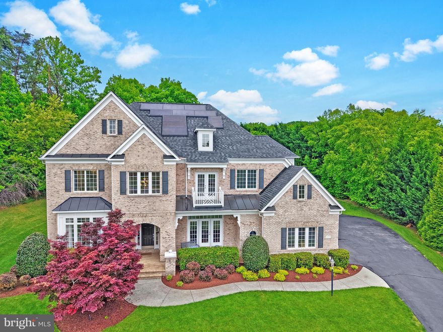 Located on a quiet cul-de-sac and set on nearly an acre in coveted Oak Hill Estates, this elegant brick-front home offers three beautifully finished levels with 5 bedrooms, 5 full baths, and 2 half baths, along with a desirable 3-car side-load garage.

A welcoming front porch leads into a bright, open floor plan featuring arched entryways, a dramatic two-story foyer, gleaming hardwood floors, and upgraded metal balusters. The main level includes spacious formal living and dining rooms, a private library, and a stunning family room with coffered ceilings and a stone fireplace that opens to the gourmet kitchen. The kitchen is designed for both everyday living and entertaining, complete with a large center island with secondary sink, stainless steel appliances, granite countertops, walk-in pantry, and an expansive breakfast area, plus an adjoining morning room filled with natural light. A functional mudroom offers a built-in desk, ample storage, and a large walk-in closet.

Upstairs, you’ll find stunning hardwoods in the upper hallway leading to four generously sized bedrooms. Each bedroom has an en-suite bath and a walk-in closet. There is also a versatile loft space and a large laundry room. The luxurious primary suite features a double-sided gas fireplace, a private sitting room, and 2 oversized walk-in closets. The spa-like primary bath includes a soaking tub and a seprate seamless glass shower and dual granite vanities.

The finished lower level provides exceptional additional living space with a large recreation room, fifth bedroom, full bath, and a flexible den ideal for a home office, gym, or guest suite. Additional highlights include abundant storage, a wet bar rough-in, and walk-up access to the private backyard.

Enjoy outdoor living on the spacious patio and screened porch, perfect for entertaining or relaxing. Ideally located close to shopping, dining, and everyday conveniences, this home offers a perfect blend of luxury, comfort, and functionality.