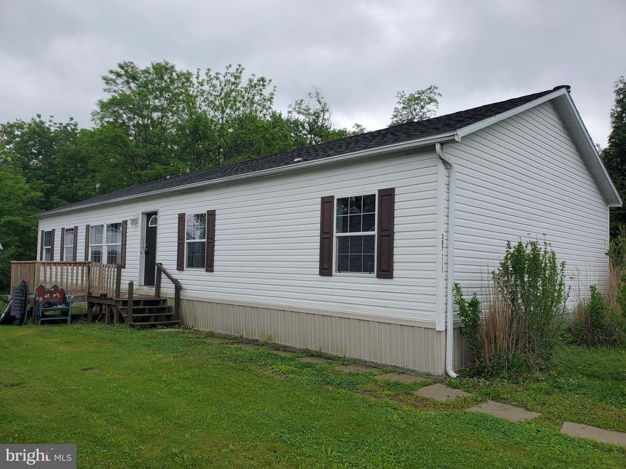 Country mobile home park.  This spacious modular home has 3 bedrooms  2 baths.  Living room and family room.  Family room has wood fireplace and built in book cases.   Come check it out.