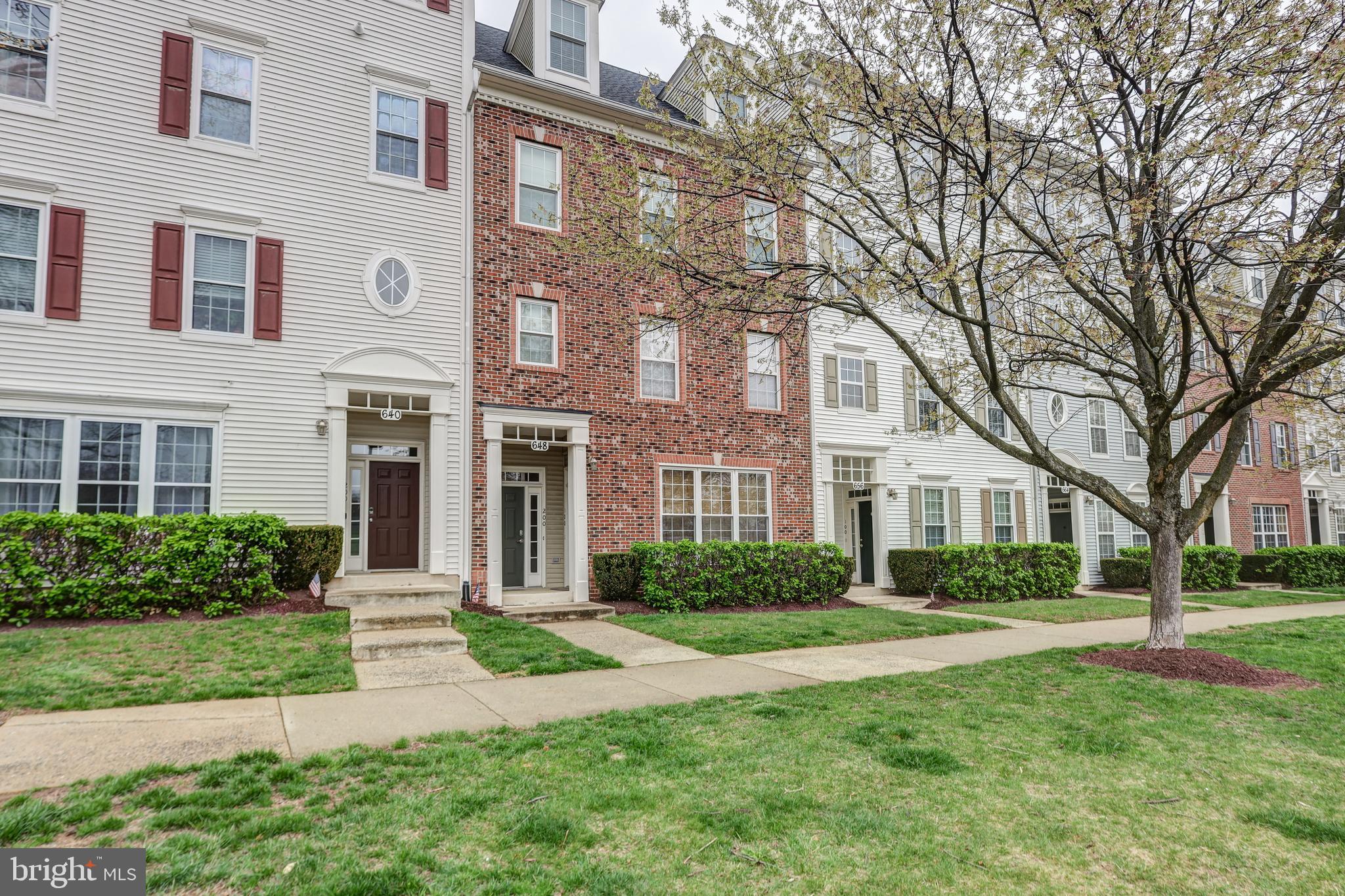Nestled in the highly sought-after Quince Orchard Park community, this expansive, light-filled townhouse-style condo offers over 2,600 square feet of elegant living space. With a charming brick façade and dormer windows, the exterior exudes classic appeal while remaining virtually maintenance-free.
Ideally situated just steps from the community pool, clubhouse, and gym, this home combines luxury and convenience in one perfect package. Inside, natural light pours through every room, highlighting the fully renovated interior. This turnkey three-bedroom, two and a half-bath home includes an attached one-car garage and is truly move-in ready.
The beautifully updated kitchen features stunning beveled-edge granite countertops, a stainless steel sink, modern appliances, and new flooring. A 5-foot bump-out provides ample space for a kitchen table, bathed in sunlight, or you can step out onto the gorgeous Trex deck.
Elegant crown molding, fresh paint, and upgraded neutral carpeting flow throughout the home. Upstairs, you'll find three generously sized bedrooms, including a luxurious primary suite with soaring cathedral ceilings, a spa-like en-suite bath with dual sinks and mirrors, new flooring, and an oversized walk-in closet. The two additional bedrooms also feature vaulted ceilings, abundant closet space, and ceiling fans in every room.