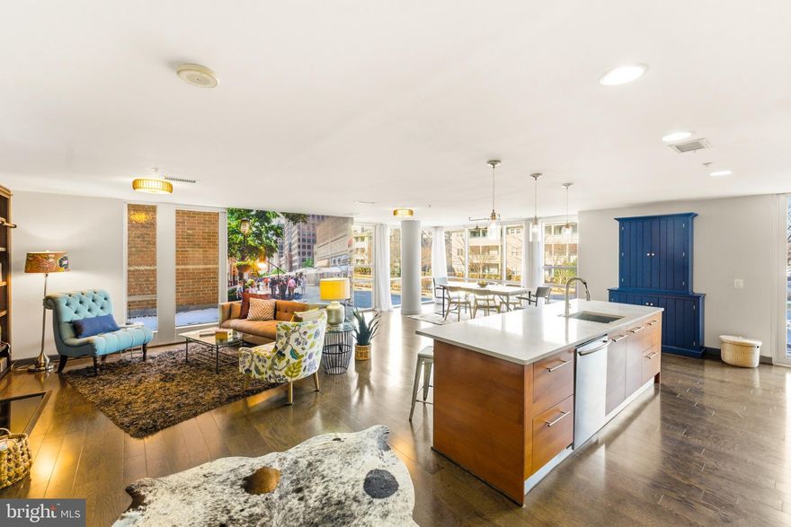 Can't Miss this full package.  Just Listed corner two-bedroom, two-bath gorgeously renovated residence at Midtown North with 1,702 square feet, 2 Garage Spaces, extra storage, and walkability second to none! Renovated with designer finishes, upgrade your life with this unit boasting rich hardwood floors, walls of windows overlooking New Dominion and flood the space with natural light, and a large private balcony to enjoy too.  Also notable is a striking fireplace feature wall, new water heater,  two assigned garage parking spaces (on G1) and a dedicated and convenient storage unit down the hall from the unit on same level. Showpiece kitchen with a SubZero refrigerator, Wolf cooktop, Viking ovens and a Braun dishwasher.. A motion-sensor Delta faucet adds modern convenience, while the built-out butler’s pantry area offers exceptional versatility. Right now, it's a chic office space is brilliantly tucked behind kitchen. Two assigned garage spaces plus extra storage in a full concierge building , full of community for 78 luxury residences. Enjoy spa-like renovated bathrooms, custom closet systems, and laundry room ready for more customization.  Midtown North is among Reston’s most exclusive and boutique condominium communities; this residence offers an exceptional combination of sophistication and convenience. This rare and highly sought-after split-bedroom floor plan provides the perfect blend of privacy for hosting and open-concept living.  Both bathrooms have been fully renovated (in 2025) to create spa-like retreats with elevated finishes and timeless design. The owner’s suite also features a custom closet system, delivering both style and function.
This unit also has a spacious laundry room with full size upscale machines where more cabinets and a stone folding surface can be added, a luxury not often found in 2-bed condo units. Corner two-bedroom residences in this community are consistently in demand, making this home a truly special and timely offering. Midtown North was thoughtfully designed to ensure each residence feels like a retreat and distinctly its own. This concierge building offers both discretion and security, creating a true sense of retreat. As a mid-rise community, it provides the convenience of easily accessible elevators and multiple entrances, allowing residents to come and go with ease, efficiency and privacy.
Within the building, an impressive collection of amenities enhances daily living, including a sunlit rooftop terrace with a picturesque pergola, lounge seating, lush landscaping, dining tables, and a large stainless grill; a well-appointed fitness center; an elegant penthouse lounge with a full kitchen for entertaining, guest parking and EV charging stations in the garage. Beyond the residence itself, the location is second to none. Just steps from dining, shopping, fitness studios and entertainment at Reston Town Center, you’ll enjoy effortless access to everything that makes Reston so desirable. Explore miles of scenic trails, lakes and green space throughout Reston, Virginia, along with convenient access to Metro, major commuter routes and nearby business hubs.