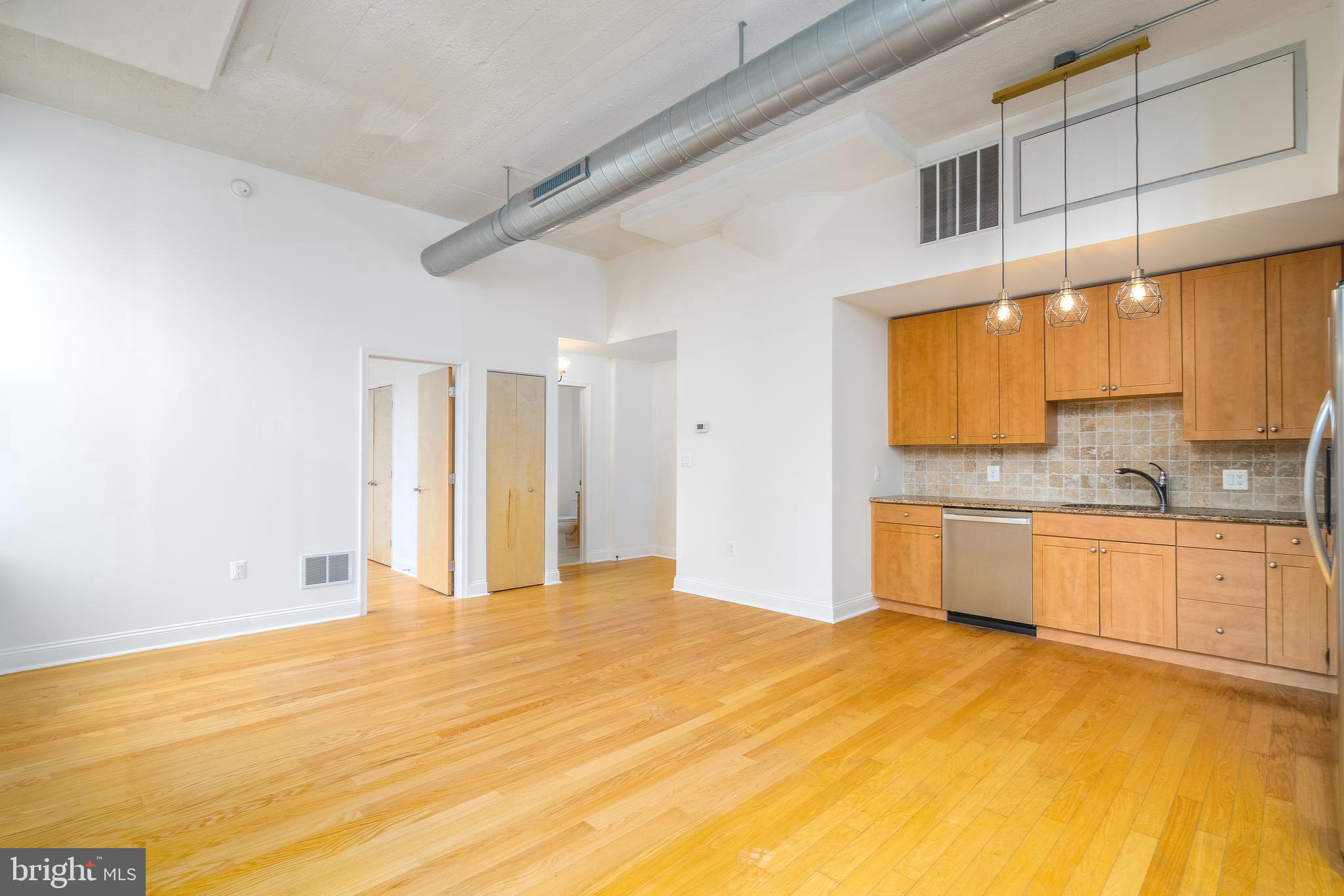 Unit #402B at Philly's landmark Marine Club Condominiums is a sun-soaked 2 bed, 2 bath apartment offering in-unit laundry, central a/c, and a garage parking spot! Full of amenities, this building has a welcome desk staffed 24/7, an idyllic courtyard, and a state-of-the-art fitness center. Inside the unit, you'll find an open and airy layout at the center with hardwood floors, soaring ceilings, and massive windows overlooking the courtyard. You can easily create a separate living room and dining area. The kitchen is fitted with shaker-style cabinetry, granite counters, a tile backsplash, and stainless steel appliances including a dishwasher. The primary suite sits on one side of the apartment. It has a large bedroom with a bright window, a walk-in closet, a laundry closet, and an attached full bathroom with a glass-enclosed shower and a soaking tub. The second bedroom and another full bathroom are on the other side of the apartment. In addition to everything inside, this fantastic location earns a Walk Score of 97! Tons of top-rated restaurants and friendly shops are within a few blocks. Just across the street, there's a Target, Sprouts Farmers Market, Wine & Spirits, and PetSmart. Plus, there's easy access to public transit, Broad St, Washington Ave, Center City, Rittenhouse Sq, Jefferson Hospital, and Pennsylvania Hospital. Schedule your tour today!