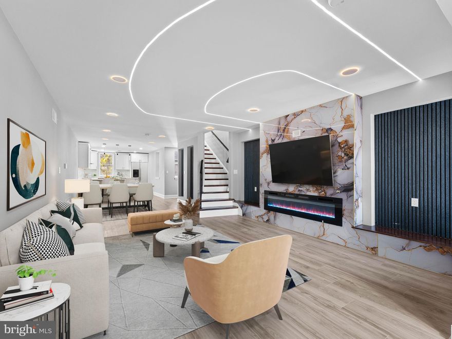 Welcome to 1130 S 54th St, a beautifully redesigned 3 bed, 2.5 bath home in West Philadelphia. Completely rebuilt from the studs up with all new electric, plumbing, HVAC, flooring, and lighting. The spacious 16-ft-wide layout features a custom accent wall, LED lighting, and electric fireplace, plus a convenient first-floor half bath. The eat-in kitchen offers ample counter space and will include brand-new stainless steel appliances. The finished basement adds a full bath, laundry, tall ceilings, and outside access—perfect for a gym or bonus living area. Upstairs are three large bedrooms and a modern full bath with high-end finishes. Close to shops, restaurants, universities, hospitals, and public transportation—this home is truly move-in ready!