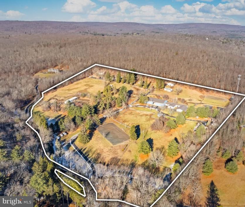 Explore Pleasant Ridge Farm an exceptional Commercial Equestrian Facility with 8 single family homes and one duplex.Within walking distance of State Game Lands and Buck Hill Falls trails and 27 hole golf course. 26.4 acres & 23.73 acres zoned commercial hotel/resort this property offers unparalleled potential. Was once a bed and breakfast. The main Barn has 7680 Sq ft. with a heated view room/ bathroom, wash stall with hot/cold, & 21 matted stalls. Property is cleared with trees defining the boarder.
Key Features of the Property:
*122 Barn Swallow Lane
This parcel allows agricultural use and is the only parcel zoned residential, with 3.03-acres providing space for potential expansion.
*117 Lynn's Way
A 7.12-acre parcel featuring a 2,600 sq. ft and 1,800 sq. ft. metal pole barn built in 1965 with a 192 sq. foot shed. This property is zoned commercial and offers space for agricultural or resort-related development.
*130 Barn Swallow Lane (Rental Units & Commercial Equestrian Facilities)
*Spanning 9.19 acres, this parcel contains a duplex, a single-family home, and the impressive 7,680 sq. ft built in 2012 provides ample space for resort expansion, equestrian facilities, or other commercial uses. This site is currently utilized for rental purposes, generating income while offering development potential.*Please see attached document for earning reports per property.
*150 Barn Swallow Lane (Residential & Resort Potential)
This 7.06-acre property features six single-family homes, ideal for income generation or as a residential component to a future resort development. Zoned for CRH, this parcel has great potential for a mixed-use resort or commercial resort-hotel project.
Perfect Location for Resort Development
Located just 15 miles from some of the region's most popular resorts, including Kalahari, Great Wolf Lodge, Camelback Resort, and Skytop Lodge, this property is perfectly situated to capitalize on the growing resort market. Its mostly commercial zoning for CRH makes it an ideal site for the development of a resort, hotel, and or continue the use as a commercial equestrian facility, all in close proximity to major attractions.