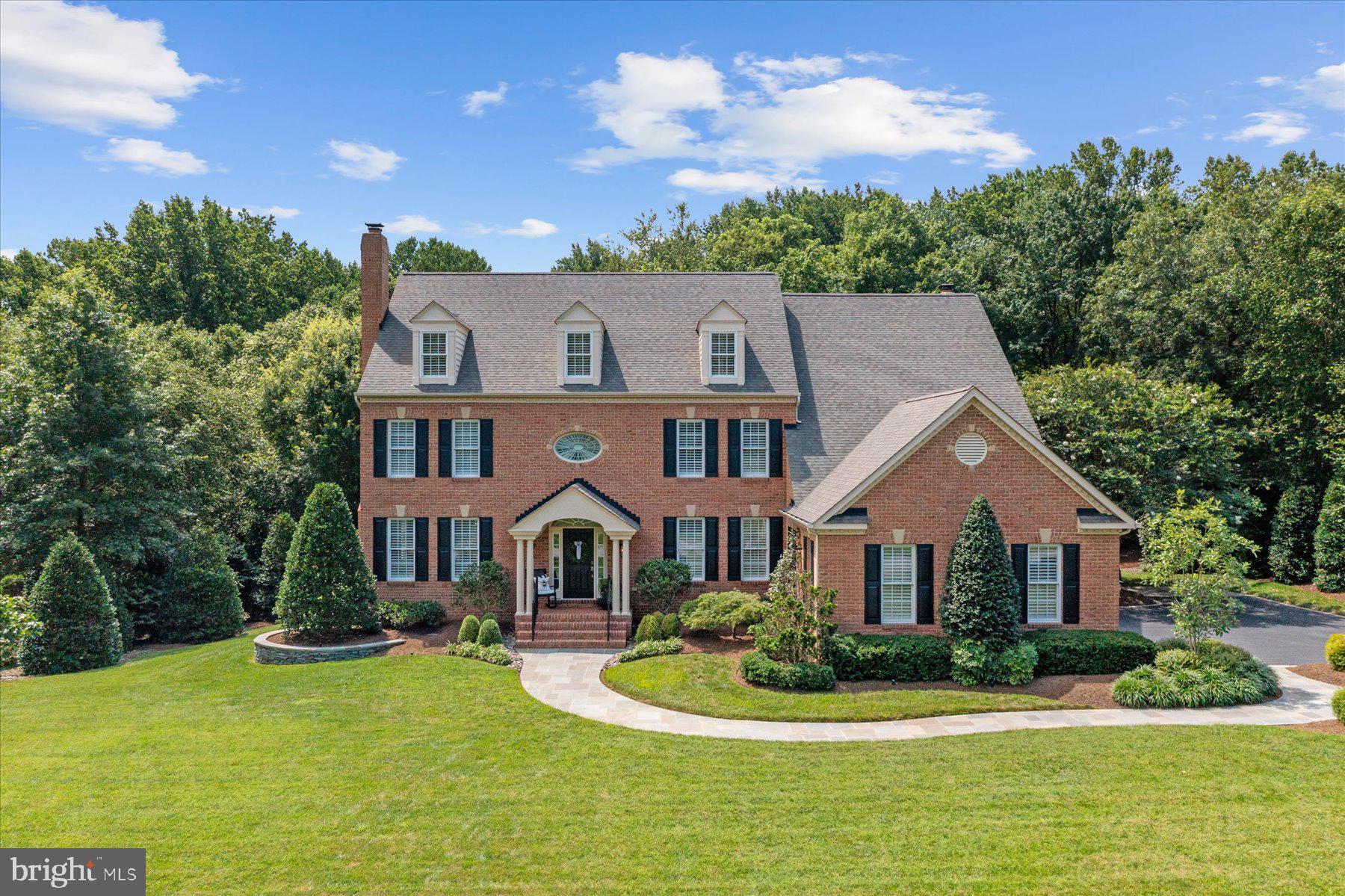 Luxury Living Meets Unmatched Privacy in the Heart of Gambrills!
Located within the sought-after Crofton school district and the 5-year young Crofton High School, this custom-designed 6,000 sq ft home sits on 2.91 private acres, offering an exceptional blend of timeless style and modern functionality. Renovated in 2017, this 4-bedroom, 5.5-bathroom residence features 7.5” engineered white oak flooring, custom millwork, shiplap accents throughout, and two beautiful wood-burning fireplaces. The large gourmet kitchen is the heart of the home, complete with custom cabinetry, granite countertops, a full suite of premium GE stainless steel appliances, a large custom-designed walk-in pantry, and bar equipped with a standalone ice maker and beverage fridge with Maryland-sourced wood countertop. The 8’ island easily seats five, making it perfect for gathering with family or hosting friends.
Each of the 4 bedrooms boasts its own en-suite bath and large walk-in closet. The luxurious primary bath is adorned with honed marble finishes, built-in linen closet, frameless glass shower and marble vanity with double sinks for added functionality. The custom shiplap tray ceiling, amazing natural light and two large walk-in closets make this expansive primary bedroom a welcome retreat. Additional conveniences include a dreamy second-floor laundry center with abundant storage and folding island, plus two custom home offices—perfect for remote work or study.
The newly finished basement, completed in 2021, includes a spacious great room with a pellet stove, full bathroom with glass shower and versatile bonus room with walk-in closet (ideal as a guest room, fitness studio or workspace). The expansive storage area, separate workshop and spacious mechanical room with built-in shelving make keeping everything organized a breeze.
Outdoor living is equally impressive: enjoy relaxing dinners on the large covered back porch overlooking a beautifully landscaped yard, a sweeping slate patio with a stacked stone wood-burning fireplace, landscape lighting, and a natural gas line for grilling. The 30-zone irrigation system with conditioned water ensures that the property is well-maintained.
The additional 900 sq ft Carriage House, designed to complement the primary home, adds even more versatility, featuring electric, water, two 4-gallon hot water heaters, a pellet stove, ceiling fans, outdoor shower, loft space, cable and phone hook-up, and a charming rocking-chair front porch—ideal for use as a workshop, guest retreat or future pool house.
Additional features include a 3-car garage with custom built-in storage and slat wall system for additional organization as well as a large paved driveway with parking for eight more vehicles. Just a ¼ mile to Crofton High School and Middle School and less than 3 miles from Crofton Country Club, this estate offers unmatched privacy, space, luxury, and convenience. All this and close to DC, Baltimore and Annapolis with easy access to Rte. 50 and I-97. BWI Airport is just 12 miles and Washington National Airport just 23 miles, making travel easy. Minutes to Wegmans, Fresh Market, Safeway, Giant, Aldi, and dozens of shops and restaurants along Rte. 3