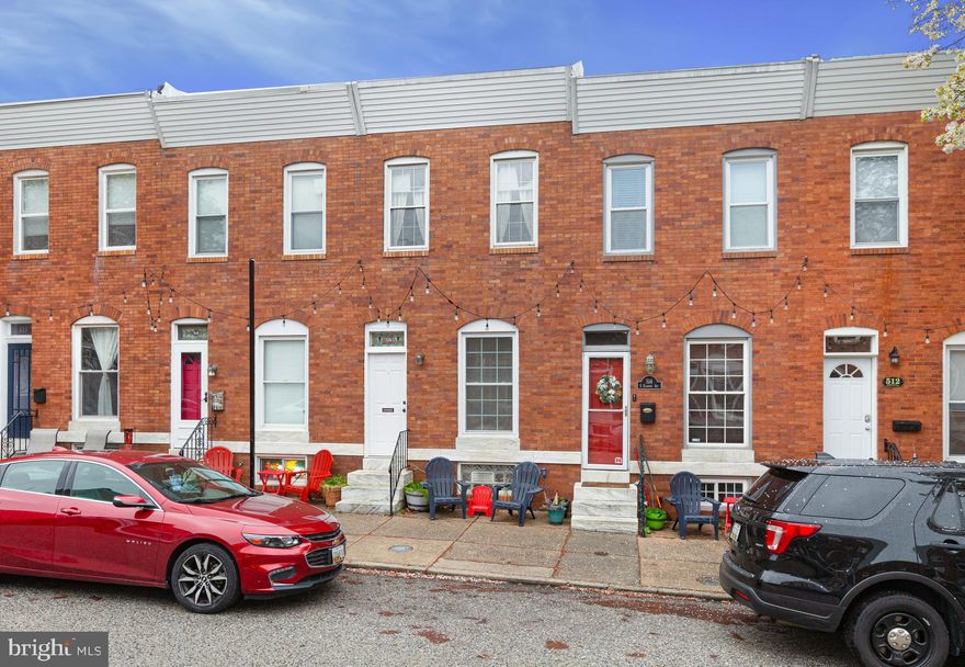 This charming brick front rowhome is located on a beautiful tree lined street just steps off Patterson Park.  If you are looking for both indoor & outdoor space, this one is for you!  Large pad in rear with electric gate (can be used for private entertainment space or SECURE PARKING) plus an enormous two-tier deck on upper lvl & roof with spectacular views.  Enter through a classic Baltimore City portico to a nice & spacious open concept living/dining area with hardwood floors.  Wide kitchen with exposed brick & modern backsplash leads to mudroom which is a rarity in the city.  Hardwoods on upper lvl with 2 bedrooms & a flex space that can easily be converted to master bath or used for office/den/exercise, etc. Spacious primary bedroom with lots of sunlight.  Second bedroom leads to two levels of enormous decks perfect for entertaining. Unfinished lower level provides much needed storage and laundry area.  Close to 95, John's Hopkins, Harbor East/Inner Harbor, Patterson Park, Fells Point & all the areas shopping & attractions.  This one has it all, inside & out!