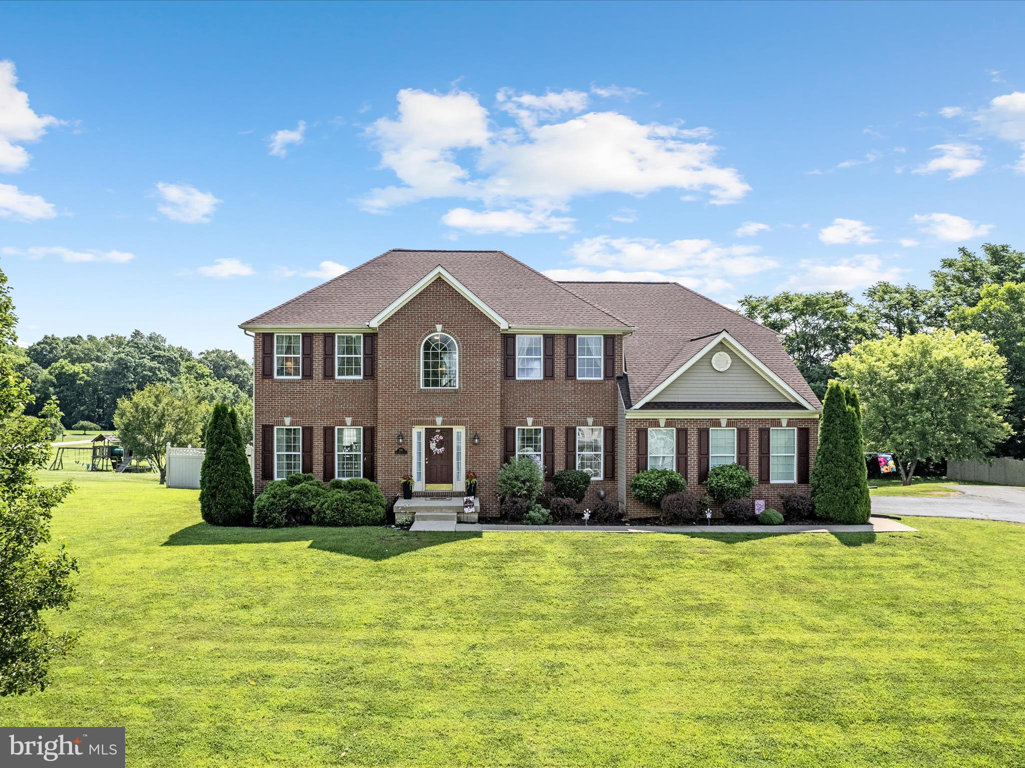 Updates galore! This bright and beautiful, brick-front residence located in a quiet community outside of Shepherdstown features many enhancements for its next owners to enjoy, including LVP flooring that flows through most of the main level, updated lighting and door hardware, fresh paint, and refreshed bathrooms. Situated on a 1.24-acre lot, this stunning property has a spacious, fenced back yard with fruit trees and garden beds along with a huge back deck that's perfect for both entertaining and day-to-day living. The open-concept floor plan emmanates from the remodeled kitchen that's accentuated by gorgeous white Quartz counters, a conventient double oven, built-in desk area, island with breakfast bar seating, and a generously sized storage pantry. A large family room with gas fireplace, separate formal dining and living rooms, a private office near the 2-story foyer, and the laundry room complete the main level. Upstairs, the elegant primary suite is a true retreat offering an oversized walk-in closet and updated ensuite bath with a luxurious soaking tub, new shower enclosure, LVP flooring, and updated Cararra Quartz vanity with dual sinks. There's also a princess suite with an additonal attached bathroom plus 2 more bedrooms that share another full bath. The unfinished, walk-out lower level affords much opportuity for storage, recreation, or future expansion. There's also a 2-car side entry garage, plenty of driveway parking for guests, and established landscaping that adds an inviting touch. This home is easy to show and very accessible to commuter routes and local attractions. Make this turnkey home yours today!