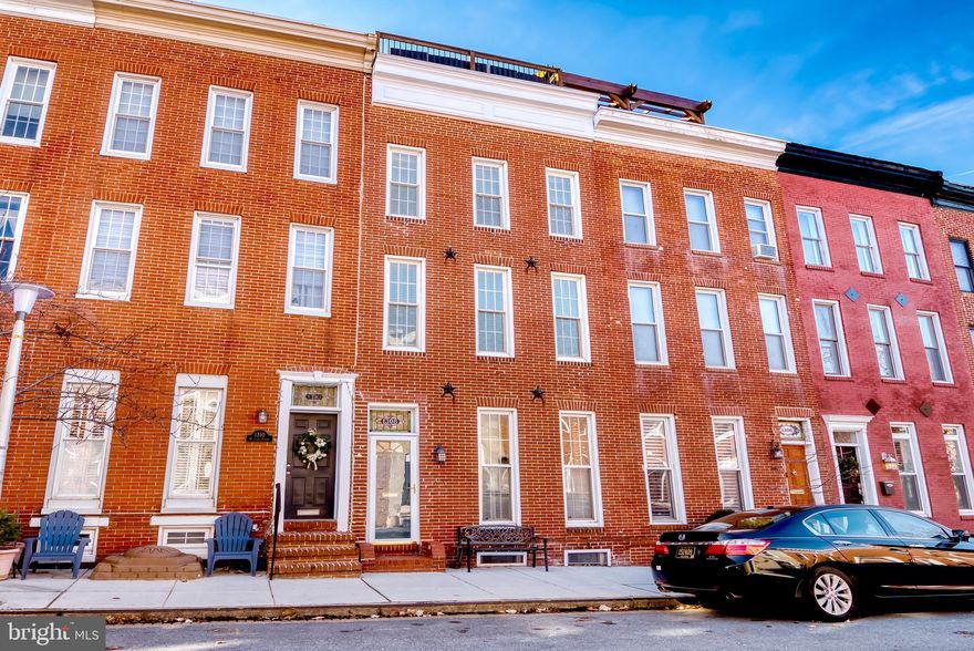 Charming, extremely wide 3 Bed 3.5 Bath with Rooftop Deck and PARKING on one of Federal Hill's most coveted streets! Expansive width with beautiful original Hardwood floors, brick accent walls and stunning 1800s curved staircase. Formal dining room, updated kitchen with Stainless appliances, granite & center island. Mudroom, 1/2 bath and Laundry are in convenient location off of rear Parking pad entrance. On the upper levels you'll find 3 gigantic above ground bedrooms each with private Bath and double rooftop deck with sweeping views of downtown Baltimore! Centrally located in Federal Hill within minutes of restaurants, shopping and nightlife. Close proximity to Johns Hopkins, University of Maryland, Downtown, I95, I295 & I83. Pets Considered, Available for Short Term Lease and home is available fully furnished for additional fee!