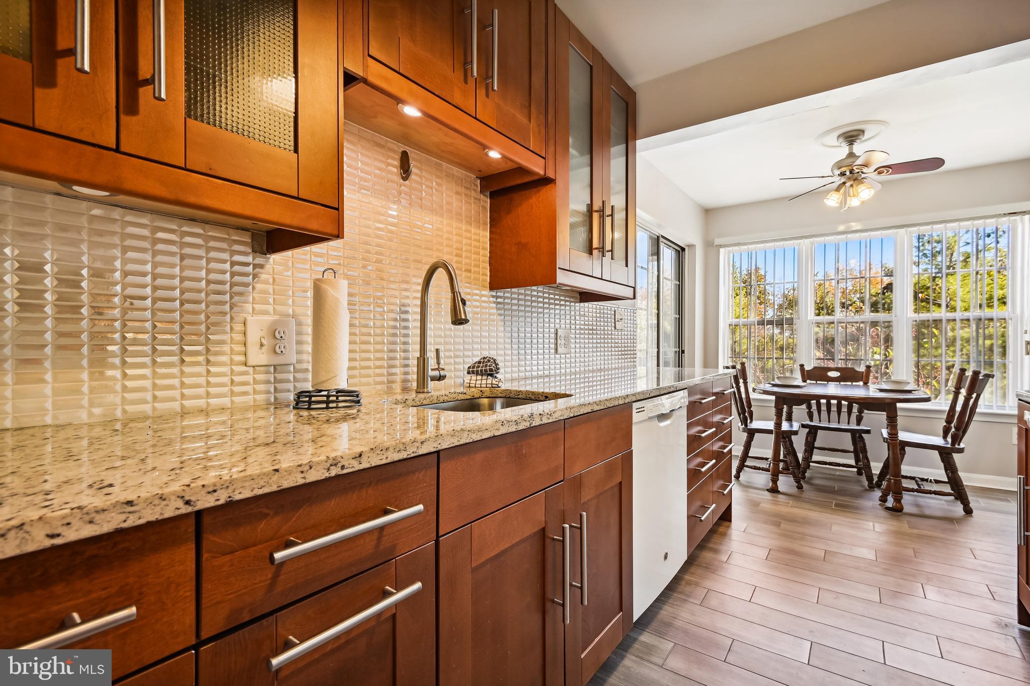 Light-filled penthouse condo with 2 bedrooms and 2 full baths in amenity rich Cromwell Fountain. This open concept home offers vaulted ceilings in the living and dining rooms. The living room has plantation shutters on the slider leading to the screened porch. Sleek modern kitchen with luxury vinyl plank flooring, granite counter tops, maple cabinetry, backsplash, and breakfast room with ceiling fan and second glass slider to access the screened porch. Laundry room with front-loading washer & front-loading dryer off the kitchen as well. Two bedroom suites, each with ample closet space and ceiling fans. Updated baths with contemporary freestanding vanities, ceramic tile, decorative mirrors and more. Amazing community amenities include secure building, tennis courts, pool, clubhouse, tot lot & more. Close to shopping and dining. Convenient to Washington, Baltimore, minutes to BWI. The entire unit has been upgraded with high-end products and in a great location too!