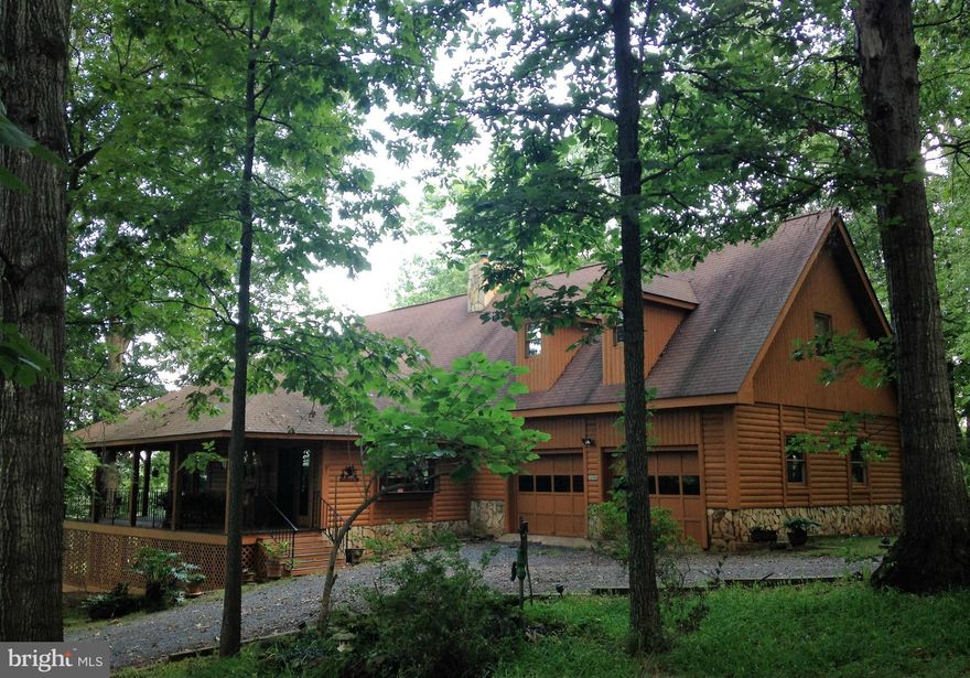 Peaceful, private & truly magical. Custom 4 BR, 2.5 BA Log Home with Soaring Cathedral Ceilings, 2 Lofts, Impressive Stone Fireplace w/ stove insert, & hardwood floors throughout! 10 acres, partially cleared, fenced on 2 sides. Spend time on the wrap around porch & enjoy wildlife and gorgeous mountain views! Includes a 1 Yr. Home Warranty & Priced $30K below recent appraisal, so don't wait long!