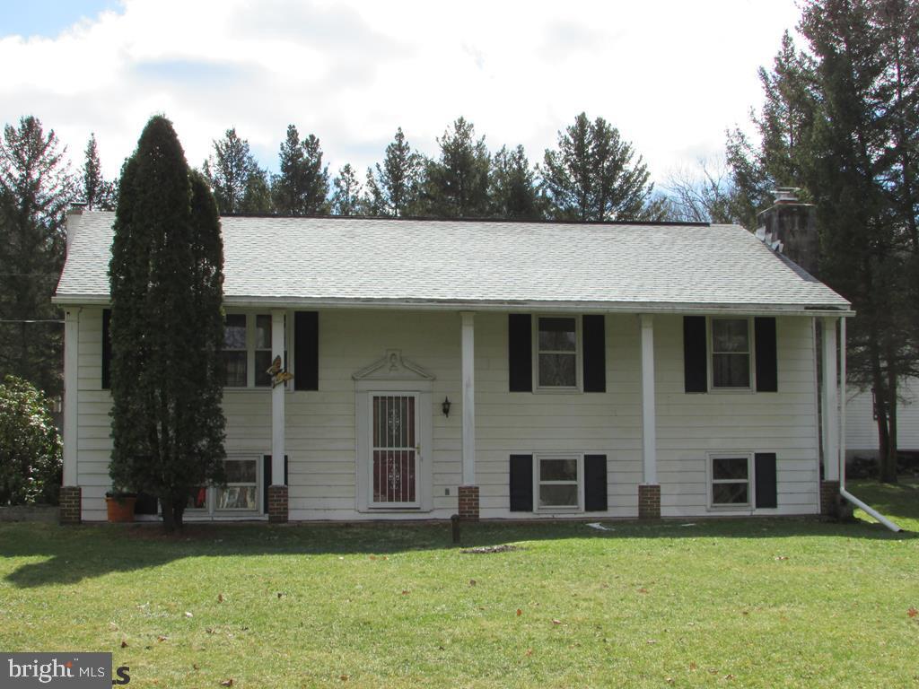 Carpet upstairs in the living room, and hallway has wood floors underneath.The master bedroom on the main floor along with the other two bedrooms have hardwood floors.The lower level has a beautiful wood inset fireplace encompassed by brick. Visit Virtual Tour at https://rem.ax/2GeqBUH