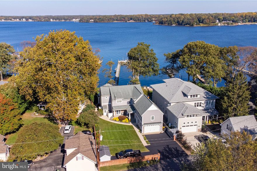 Gorgeous Magothy River waterfront home. Built in 2010 from the ground up. With 5 bedrooms and 3.5 baths in the main house and another bedroom and full bath in the apartment, this home should cover all your needs. Use the apartment with private entrance over your 2 car garage for an in-law suite or extra income. When you see the water views from just about every room in the house, you won’t ever want to leave. Wake up each morning to water views right from your bed. Sip your coffee on the patio overlooking the serenity of the river. Enjoy dinner on the deck while you watch the most amazing sunsets. End your evening with a glass of wine by your fireplace.  Launch your paddleboard, kayak or canoe from your own sandy beach.  Boat, fish, or catch fresh crabs right in your own front yard! Deep water pier on a wide area of the Magothy.  The 300ft pier includes 15,000 lb boat lift, jet ski lift and room for up to 5 boats. Jump on your boat and be at the Bay Bridge in no time! Outdoor space is an entertainer's dream.
The details in this home are too numerous to count.  On the main level, the open floor plan and French doors along the entire waterfront allow for amazing water views. The stone fireplace is the centerpiece of the living room. Custom tray and coffered ceilings.  Gourmet kitchen with double wall ovens, cooktop and hood range.  Granite counters, glass backsplash, ice maker and wine cooler. Upstairs there are water views from 3 bedrooms. The master bedroom has a large bath with a double vanity, soaking tub,  and open shower.  Storage is no issue with plenty of closets, 2 attics, 2 crawl spaces, and a shed. Ample parking with a 2 car garage and 2 parking pads that have been newly coated. The rear and front yard have an irrigation system. The apartment is 1 bedroom, 1 bath with a kitchen and washer/dryer.
Waterfront living at it's best, doesn't get much better!