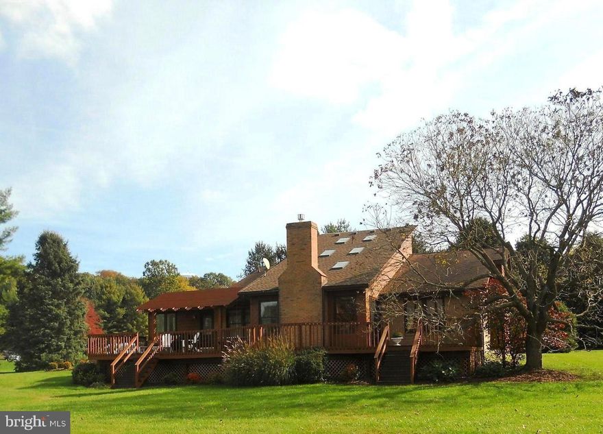 Welcome to this 4 Bedroom, 2 1/2 Bath Contemporary nestled on 1.48 acres backing to Wakefield Valley,  and  a walking/running nature  trail.  Privacy abounds with the beautifully landscaped yard surrounded on 2 sides by mature trees. Enjoy sunsets and a panoramic view from the expansive deck with pergola, multiple dining areas, and room to relax. Imagine spending time with family and friends  in the spectacular living room (15'x35'), with gas fireplace and vaulted ceiling.  The main level with neutral decor features a primary bedroom w/en suite bath and dressing room.  Two more ample sized bedrooms, hall bath, kitchen with breakfast bar, formal dining room and a light filled den are all on the main level.  Spiral staircase to second floor with new carpet  features another generous sized bedroom, and an additional room tucked away,  perfect for a quiet home office,  guest room, or exercise room,  plus a loft with sitting area.  Amenities include new skylights, French door,  replacement windows, crown molding, Corian countertops,  ceramic tile floors,  and new heat pump/air conditioning (2020). There's an abundance of storage in the huge unfinished basement, with plenty of space for a man cave/workshop/rec room. Two car side entry garage & professional landscaping complete this outstanding home. 1 Year Cinch Home Warranty