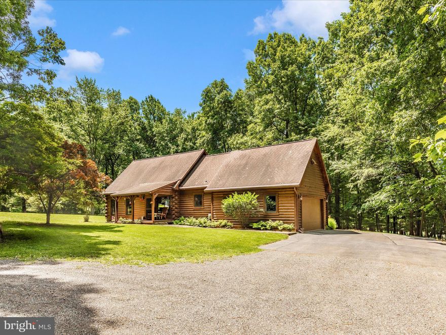 TRUE MUST SEE !!  This one of a kind Log Home has been meticulously maintained.  Main level has Large Open Living Room with high ceilings, hardwood flooring and breathtaking stone fireplace.  Kitchen boasts new luxury vinyl tile,  upgraded cabinets and countertops.  There is a patio door that leads to a three season beautiful porch with 180 views of nature !  Stunning Primary Bedroom with windows, hardwood flooring, lots of closet space, full bath and beautiful log walls on the main level.  Upper level has 2 additional bedrooms and a full  bath.  Open loft area overlooking the main level. Lower level is finished and has unique concrete flooring, wood stove and another full bath.  There is a large door leading to stairs to the backyard.  Outside is over 2 acres of nature and Privacy.  There is a deck, patio, and well manicured lawn.   This home is Western Red Cedar !  Come check us out !!