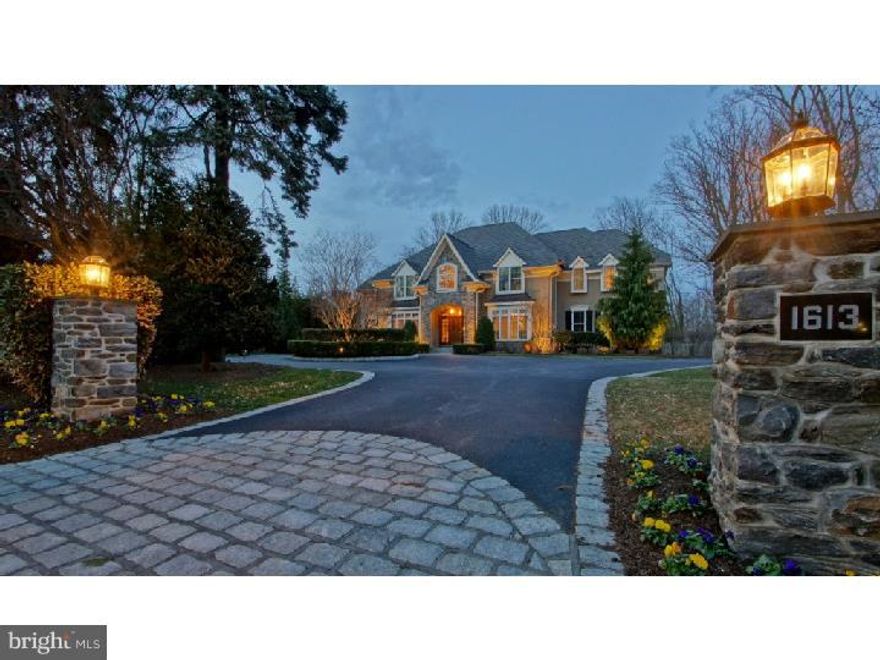 Stunning 7-year-old Tom Bentley built stone French country home with impeccable finishes and upgrades for today's discerning buyer.  Featured in Main Line Today's June 2014 issue, this 5 bedroom/4 full/1 half bath home with over 6,300 sq ft of living space has a completely renovated Gourmet Kitchen with 13 foot white Carrera marble island (5cm thick) and Sub Zero/Wolf/Asko appliances including two dishwashers, two sinks and two ovens. Opens to 2-story family room with beamed ceiling and stone fireplace as well as to a glorious post and beam timber blue stone porch with wood burning fireplace, outdoor kitchen with Wolfe grill, Phantom retractable screens, and mood up-lighting. Beautiful his and hers offices with built-ins on Main Level. Finished Lower Level w/ exercise room, luxurious bath with steam shower, and marble-topped kitchenette added in 2010, with icemaker, refrigerator and microwave. Serene Master Suite with limestone bath and professionally organized large walk-in closet. Hardwood floors on Main Level, wainscoting and extensive molding throughout, large Cedar closet, and foyer light lift.  Beautifully landscaped private yard with low voltage landscape lighting and timed sprinkler systems and Belgian Block lined circular driveway.   Near Villanova University, access to 476 and minutes from Center City Philadelphia, and Philadelphia International Airport. Square footage includes LL. Very private, wooded rear yard.