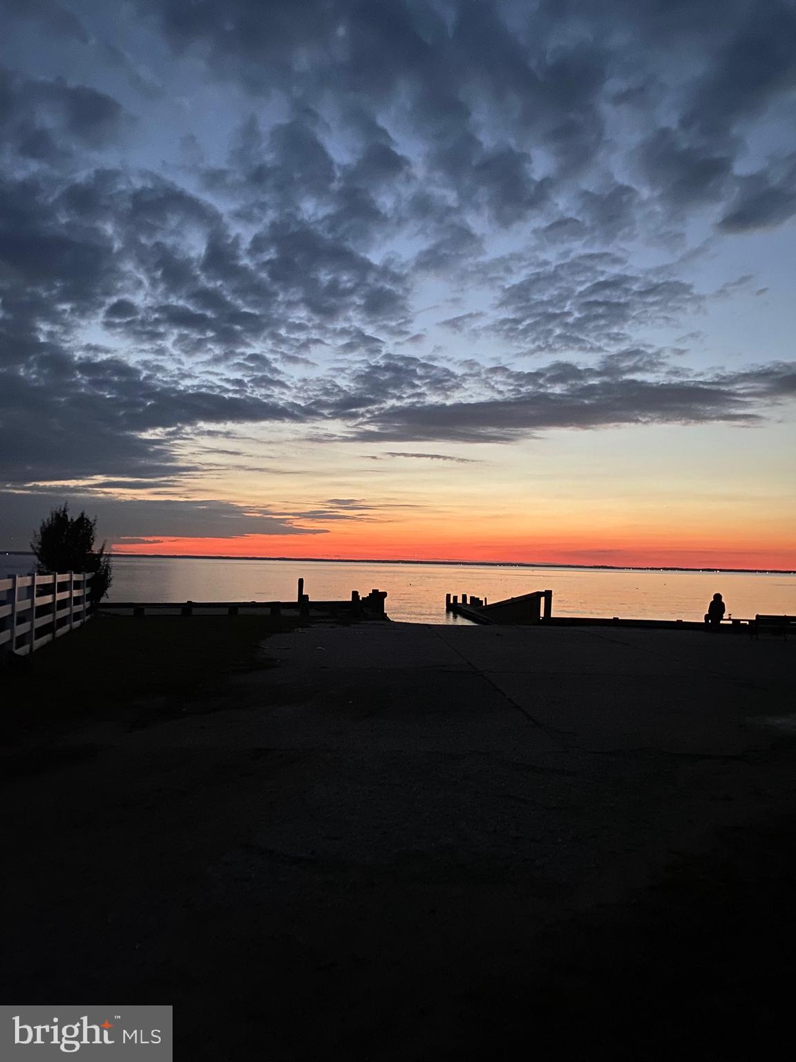 NOTE - increased in price is due to options now available, new pier, bulkhead?? New 2 car garage? call or stop by open this weekend to discuss. OPEN sat & sun 11-1. Nantucket meets the Bay in this 5 bedroom, 3-4 bath Carriage Style Waterfront. This Coastal Charmer has views from 3 sides and offers a Community Boat Ramp next door and Sandy Bayfront Beach directly across the street. Recent renovations include handsome hardwood floors, upgraded baths, new kitchen, new windows, new doors and new siding. Main level offers two bedrooms - ideal for in-law or extended family. Second level offers 2 bedrooms with full bath and a huge water view Master Suite with a sprawling balcony. Still time to customize and add your finishing touches to make this home uniquely yours. There is not a garage but with 1.5 acres there is plenty of room to add.