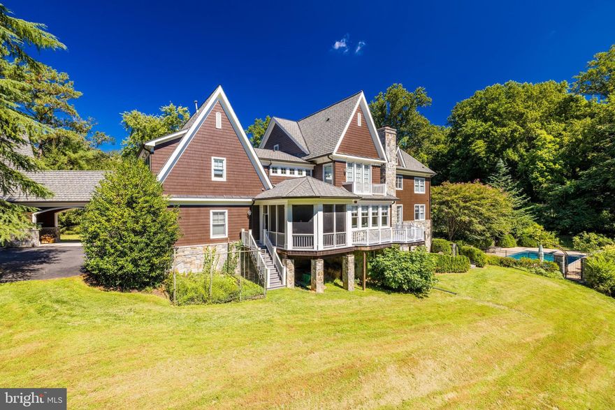 A truly special setting with six bucolic acres with rolling hills and groves of trees privately located off Bellview Road with a handsome custom built house with a four car garage plus a detached car barn that can hold 10 cars.  The two level car barn has a hydraulic lift and has heat and electricity. Custom built by Bowa Builders, this beautiful home has over 9000 sf of living and has an open floor plan with spectacular views from every window on all three levels. The property includes a pool, expansive patio, large screened porch and sport court.