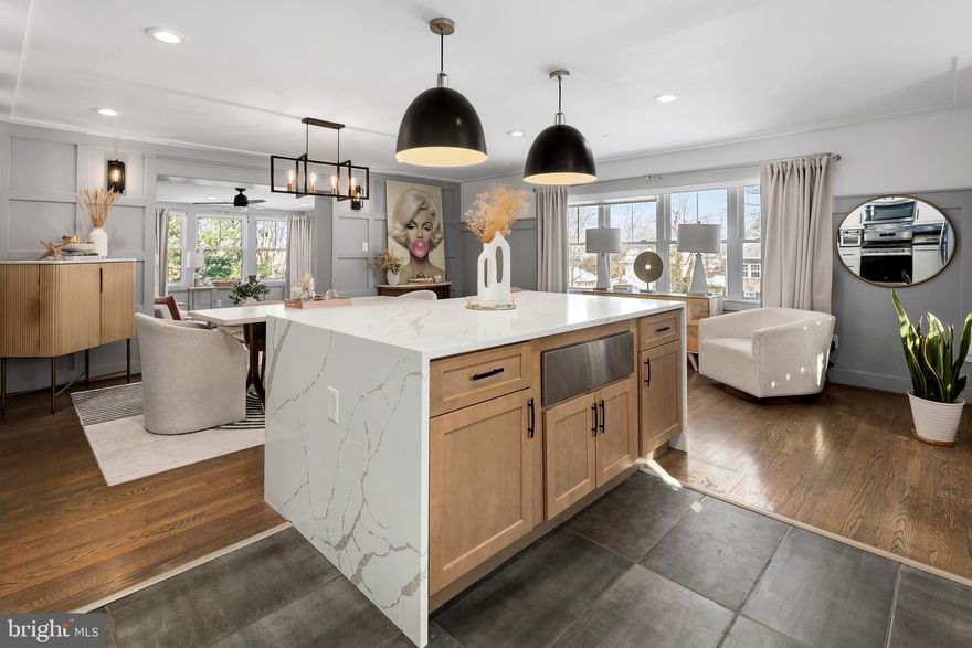 Completely renovated, this stunning 5-bedroom, 3-bath home is ideally located just down the street from Huntington Metro, minutes to Old Town, and only 15 minutes to DC via I-495. A fully fenced landscaped yard with mature trees creates a welcoming first impression. A two-car garage and expansive driveway offer ample parking and everyday convenience. The open main level is filled with natural light and features a beautifully updated kitchen with quartz countertops, an over-sized waterfall-edge island to include a warming drawer, stainless steel appliances, and custom cabinetry. The kitchen flows seamlessly into the formal living and dining area, highlighted by custom wainscoting and hardwood floors. Just beyond, a sun-filled living room offers a fireplace, custom built-in bookcases, and a wall of windows—creating a serene, treehouse-like retreat. The primary suite overlooks the expansive, fully fenced backyard and includes a spa-inspired ensuite bath and its own private laundry. Outdoor living and entertaining is complete with a patio, built-in seating, and lighting. Partially finished shed with electricity is ready to become your own personal yoga studio, workshop, or creative space. Two additional generously sized bedrooms and a beautifully updated hall bath complete the main level. The lower level is an entertainer’s dream, featuring a fireplace, spacious family room, and a fully updated secondary kitchen with buffet serving bar and wine refrigerator. Two additional bedrooms on this level provide flexible options for a guest suite, home office, or multi-generational living, with a second laundry area. The lower level also offers private access from the garage, adding built-in value and versatility. Every detail has been thoughtfully designed and updated—this home is truly move-in ready. Welcome Home!