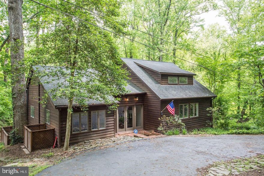 This one-of-a-kind home is a must-see. Set on 1.28 acres across two parcels, the property offers a peaceful retreat surrounded by lush landscaping and views of a private stream. Inside, the beautifully updated home is filled with natural light and features a contemporary design, hardwood floors, and a charming brick fireplace. The gourmet kitchen includes granite countertops, custom cabinetry, and built-in stainless steel appliances. Elegant bathrooms and spacious walk-in closets with built-ins enhance each bedroom. The primary suite offers a sitting area and a private balcony. All bedrooms are conveniently located on the main level. Step outside to an expansive rear patio, ideal for relaxing or entertaining.

AVAILABLE FURNISHED.