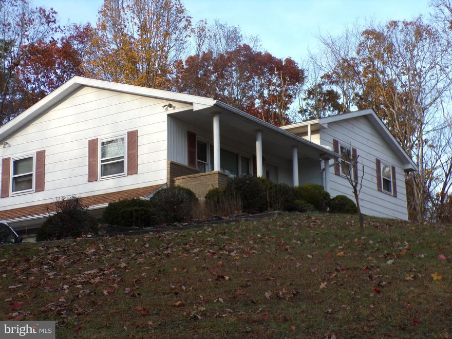 Welcome to this inviting 4 Bedrooms, 2 bath split level home, perfectly sitated in a peaceful, private setting.  This property offers a wonderful blend of comfort, functionality, and charm.  Step inside to find a bright and spacious layout, ideal for both everyday living and entertaining.  The main level features a welcoming living room that flows seamlessly into the dining room and kitchen, 4 comfortable bedrooms and a full bath.  The basement level contains family room , full bath, laundry , utility room and a one car built in garage.  For car enthusiasts or those in need of extra storage, there is also a one car detached garage with a full bath and a one car carport.  Enjoy relaxing on the front porch, perfect for morning coffee or greeting guests, or unwind on the rear enclosed porch, overlooking the tranquil backyard.  This well maintained property offers privacy and practicality, making it a wonderful place to call home!  The property has recently been surveyed and contains 9.2595 acres+-.