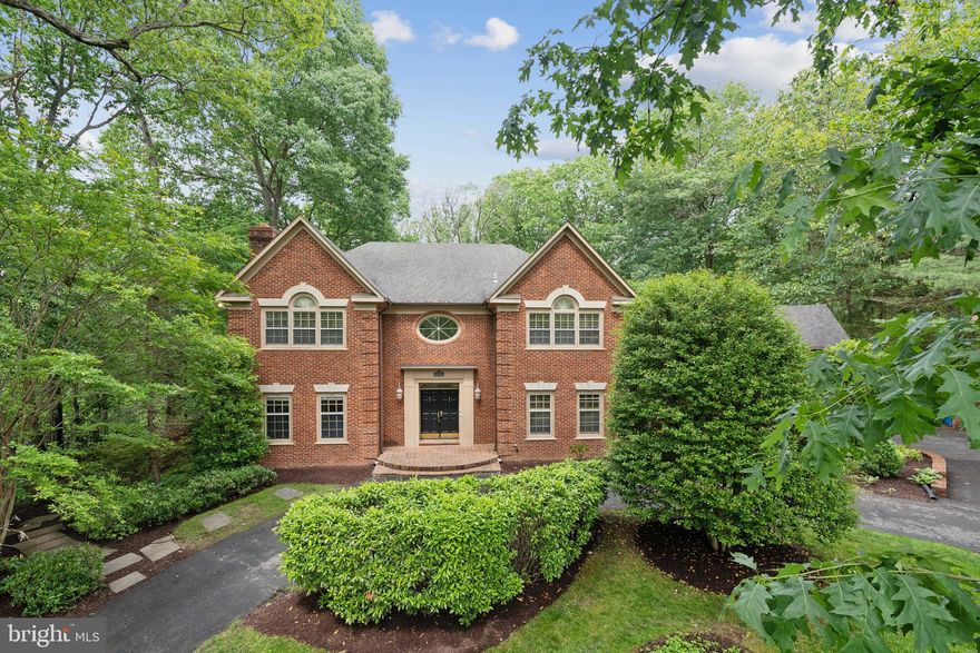 Welcome to 8702 Old Dominion Drive — an extraordinary 5-bedroom, 4 full and 2 half-bath residence spanning over 6,900 square feet of timeless elegance with modern touches. 

From the moment you enter, you're welcomed by a breathtaking two-story foyer, accented by an eye-catching chandelier and a grand staircase that sets the tone for the exquisite details found throughout the home. Elegant crown molding, gleaming hardwood floors, and refined finishes grace every corner. 

Just off the entrance, a private office boasts a full wall of custom wood built-ins and white shutters—offering the perfect space for focused work or quiet retreat. The formal living and dining rooms flow effortlessly into one another, highlighted by a classic center fireplace that brings warmth and definition to the space.

At the heart of the home, the chef’s kitchen features granite countertops, stainless steel appliances, a central island, and ample cabinetry. A charming breakfast nook overlooks the backyard oasis and offers direct access to the spacious deck—perfect for peaceful mornings. The adjacent family room stuns with soaring two-story ceilings, a dramatic stone fireplace, and a full wall of floor-to-ceiling windows that flood the space with natural light and offer breathtaking views of the private pool.

Upstairs, the expansive primary suite is a sanctuary, complete with tall beamed ceilings, its own private staircase to the main level, multiple closets including a spacious walk-in, and a spa-like en-suite bathroom. Indulge in luxury with dual vanities, white marble floors, an oversized glass walk-in shower, a freestanding modern tub, and oversized arched window flanked by skylights.

The fully renovated walk-out lower level provides flexible living and entertaining space, featuring a brand-new full bathroom and powder room, new luxury flooring, recessed lighting, fresh paint, and a custom built-ins. A dedicated gym room completes the space for ultimate convenience.

Step outside to your private resort-style backyard, where a luxurious pool, hot tub, built-in seating, and expansive green space invite both grand entertaining and peaceful relaxation. Professionally custom designed landscaping surrounds the home, enhancing both curb appeal and privacy. A spacious two-car garage and a wrap-around circular driveway provide ample parking for five or more vehicles.