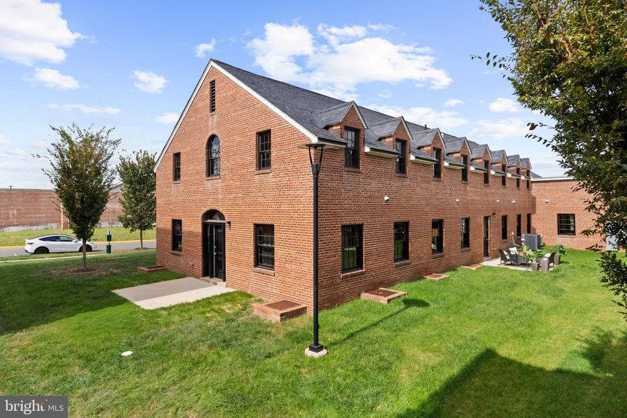 Welcome to the Quarters at Liberty, a collection of six new 1-2 bedroom, two-level condominiums
developed by The Alexander Company inside the historic residences of the former Lorton prison guards. The floor plan of #103 is ideal for those seeking a two bedroom home with separation between the bedrooms, whether sharing space with a roommate or house guests or creating separation for a dedicated home office far from your primary bedroom.  Guests are welcomed through a stately federal doorway, appointed with a fanlight and door lights, into a spacious open floor plan.  The main level offers an open living room, dining area, and kitchen space, convenient for entertaining. The generously proportioned kitchen offers a breakfast bar, electric range, stainless steel appliances, granite countertops, and plentiful storage.  With an industrial loft aesthetic, this spacious 1710 square foot home boasts hardwood floors, generous spaces, and historic character with modern practicality. The  spacious main level bedroom suite is appointed with an expansive walk-in closet and en-suite bathroom with a single sink vanity and large walk-in glass shower.  A home office niche, powder room, coat closet, and laundry room complete the main level.  Upstairs is a second bedroom suite with a large walk-in closet, and ensuite bathroom with shower.  Residents of the Quarters enjoy all the amenities of Liberty including the fitness room, yoga room, community center, outdoor pool, playground, and Liberty Green. Residents of Liberty enjoy shopping at Lidl, dining at Taco Rock, Yafa Grille, Ledo Pizza, and Kokee Tea, as well as working out at F-45 or Capital MMA. Parents appreciate the convenience of the renown Brynmar Early Education and Preschool at Liberty. The Quarters is conveniently located less than 1.5 miles from I-95, 5 miles from Occoquan, 9 miles from Fort Belvoir, 17 miles from the Pentagon, 20 miles from Reagan National Airport and Washington, DC.