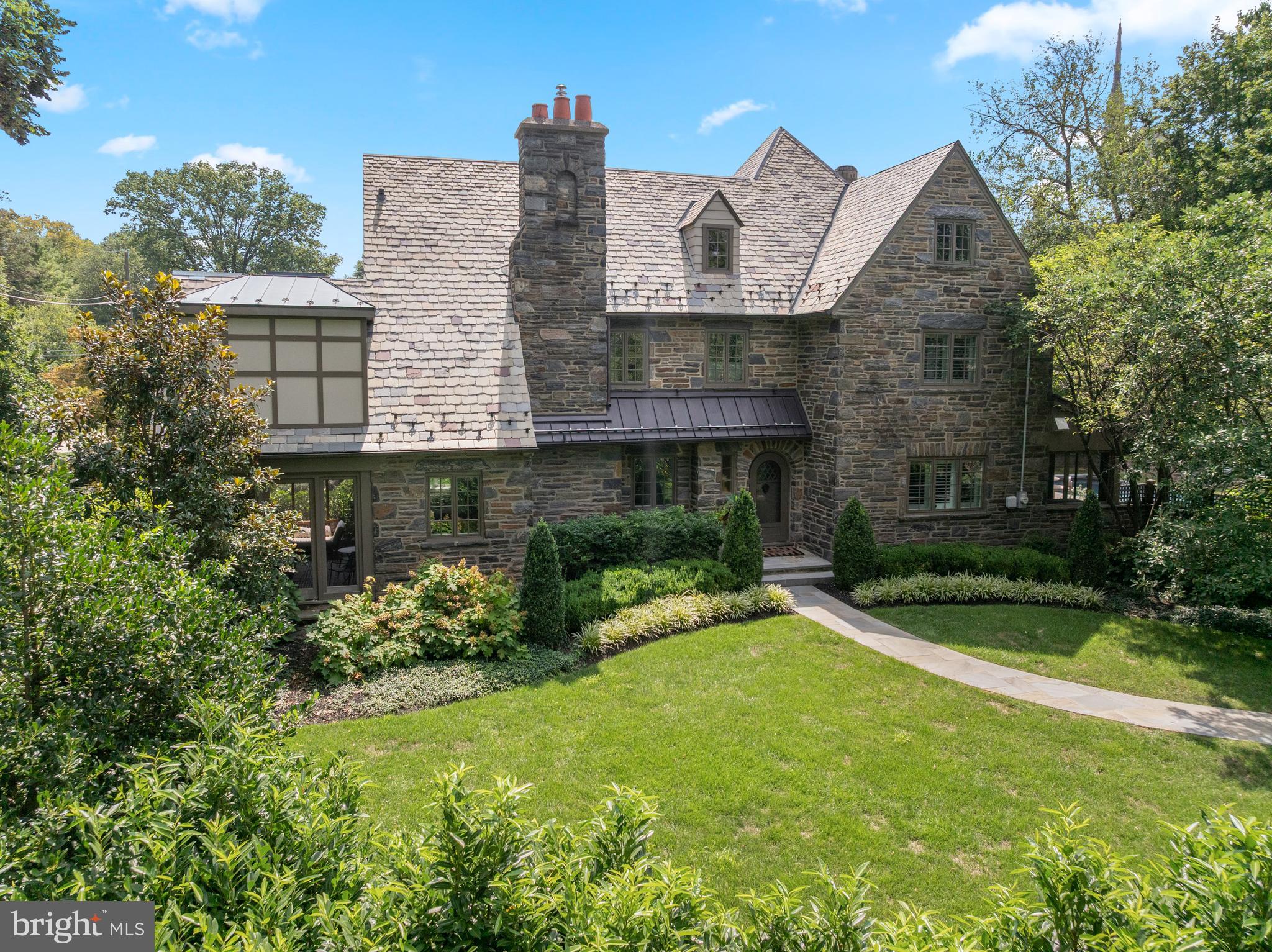Welcome to 135 Fishers Road, a North Side Bryn Mawr treasure. Inside, this magnificent, 5 bedroom and 6 full, and 1 half bathroom Center Hall stone home has been completely renovated and reimagined from top to bottom. This home is situated on a picturesque corner lot, on a highly coveted street, boasting over 5000 square feet, and is within walking distance to some of the best schools, restaurants, clubs and entertainment that the Main Line has to offer. The current owners have continued to make significant improvements to this already ultra meticulous property. They added their own sophistication and style at every turn, including elevated Japandi inspired neutral luxury interior design finishes throughout the home. The interior is the perfect blend of classic Main Line architecture blended with the finest materials, moldings, and archways that have been elevated to modern day standards. The exterior is a quintessential Main Line stone facade, with the grounds being a wonderland of lush green grass, stunning new professional landscape plantings across the whole property including privacy trees, outdoor lighting and a garden. Retreat to the heated saltwater swimming pool, or plan al fresco dinners on the large terrace. Finished with a slate roof, newly enclosed front and back porches, and a two car detached garage, this home is perfect for everyday living and entertaining! Enter the home down a sprawling flagstone walkway to a gracious front entryway. Step inside the welcoming foyer and immediately feel the warmth of this home with rich maple hardwood floors throughout, a beautiful maple staircase, and an abundance of extra large windows that provide all day natural light. To the left, you are greeted by a lovely living room complete with a custom ceiling, an open wood burning stone fireplace, a custom bar with wine racks, ceiling mounted speakers and access to the porch that has recently been enclosed to make it a "3 season" room. The current owners converted both the front and back porches to seasonal rooms. These versatile spaces have become focal points in the home. Whether it's a sunlit retreat overlooking the manicured grounds, a vibrant entertaining space, or a peaceful reading nook, these rooms are valuable additions to the home! Adjacent to the living room is an elegant dining room complete with designer wallpaper and a stunning light fixture with glass doors leading to the impressive blue slate pool deck. The gourmet kitchen is the heart of the home! The kitchen boasts beautiful white custom cabinetry, quartz countertops and backsplash, custom island, a Wolf 48 inch range with a custom hood, Subzero 48 inch refrigerator, Boshe dishwasher and a Sharp microwave drawer. The kitchen also has a beverage center to store your favorite beverages, perfect for entertaining. The kitchen opens directly to a cozy family room with a gas fireplace to keep everyone connected. The first floor is complete with a powder room. Upstairs, you will find 5 spacious bedrooms, all with ensuite baths. The luxurious primary suite includes the following spa like features, all completely customized: a tiled fireplace, an extra large walk in closet, a sitting area and a spa like master bathroom with vaulted ceilings, tiled radiant heated floors, a double vanity, toilet, soaking tub, and a shower with frameless glass enclosure. The second floor also has two additional spacious and light filled ensuite bedrooms, and a convenient laundry room. On the third floor, you will find a fabulous sitting area with vaulted ceilings, and two additional customary ensuite bedrooms. The finished lower level is also exceptional! It is complete with a newly added Movie theater AV area, a gym area, and a custom bar with tile flooring, lighted mirrors, quartz countertops, and an infrared sauna. Located in the top rated Lower Merion School District, and close to everything, this absolute GEM has it all!