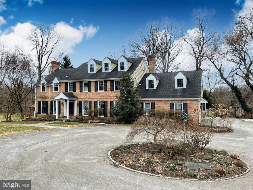 Spectacular, 5 Bedroom, 4.5 Bath, brick colonial on a quiet, cul-de-sac near Philadelphia Country Club and Riverbend Environmental Education Center. It sits on a level, 2.38 acre stunning property in sought-after Gladwyne, surrounded by open land and your own woods, with a walking path through them that this family used for mountain biking! The gracious driveway leads you past a unique gathering place - a stunning, outdoor, 2 story fireplace and sitting area to your right. It has to be seen to be appreciated. This original 150+ year old fireplace has been beautifully restored. It was the remaining bread oven/chimney from the original mansion that sat atop this little mountain a century and a half ago! Enjoy cocktails, hot chocolate or roast marshmallows as you enjoy sunset over the breathtaking Conshohocken valley below.  This spacious home boasts 5500 Sq Ft, a 2-story, center hall entranceway with wainscoting and gorgeous hardwood floors throughout. The oversized and bright Living Room with five large floor to high ceiling windows runs from the front to the back of this unique home. It also includes a wood burning fireplace and crown moldings.  Formal Dining Room complete with crown molding, chair rail and French doors opens to a tranquil oversized patio overlooking the oasis-like haven replete with gardens, grasses and hardscaping that includes beautiful pathways, stone walls and a total of three separate outdoor areas to hang out with gazebo, zip line and plenty of room for a pool. Marvelous, eat-in Kitchen has custom wood cabinetry, granite countertops, copper sink, a 6 burner Wolf cooktop, double oven and plenty of storage space. Relax in the Family Room with access to the yard, including a generous and secure fenced in area for your pets and garden beds. A second wood-burning fireplace in this family room is a great touch. Separate, spacious office/Den filled with custom cabinetry, shelving and a great enclosed bar area. Generous-sized Primary Bedroom Suite has a tray ceiling, separate sitting room and plenty of walk-in closets. Luxurious marble, Primary Bathroom is complete with a soaking tub, custom marble shower with multiple heads and his and her vanities. This bedroom level also includes three additional spacious Bedrooms and two more full Bathrooms, with a spacious Laundry Room that includes a large, new washer/dryer and drop down ironing board, hanging racks and cabinetry that keep this convenient space organized. This expansive Upper level also includes a total of five walk in and three additional large closets. Large walk-up attic with plenty of storage or future expansion.  Phenomenal finished, lower level includes two walk out sets of French doors to the second flagstone patio. This level was completely renovated in 2019 and includes a Gym with rubber flooring, Infrared Sauna, Play Room/Theater with a stunning wet bar, beverage fridge and surrounded by tasteful finishes (with additional hidden wine storage). A full Bathroom, storage and perfect in-law suite finishes this uniquely renovated space. 2-car garage with abundant shelving. 2 HVAC zones. Smart lighting, thermostats throughout. Nest cameras and outdoor lighting with motion activation supplement a great security system. Welcoming family-friendly neighborhood with year-round activities. Award-winning Lower Merion Schools. Close to 76, 476, PA Turnpike and the heart of the Main Line.