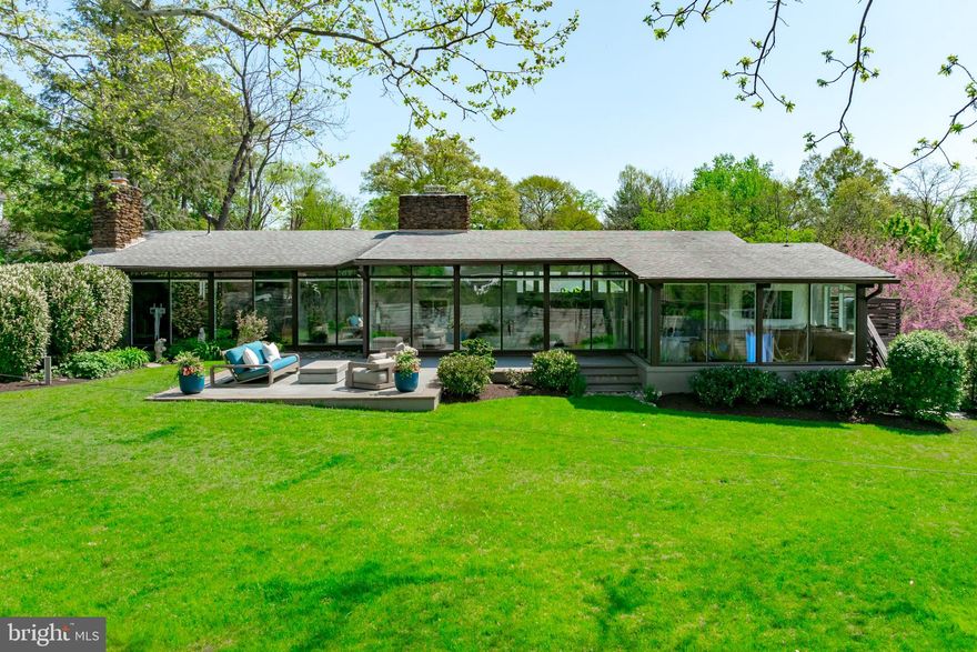 Iconic Deck Home in Pendennis Mount with views of the Severn River. This remarkable mid-century modern home has been meticulously renovated from top to bottom—and the result is something truly special. Dramatic post-and-beam construction, cathedral ceilings, and walls of glass flood the home with natural light and connect every room to the outdoors, while the open floor plan makes it as livable as it is stunning. A perfect place to enjoy views of the Naval Academy, the Blue Angels, and fireworks!
Every inch has been thoughtfully upgraded with designer-selected finishes, Restoration Hardware lighting throughout, Roman clay paint in the primary bedroom, and custom California Closets in every room. The magazine-featured chef's kitchen is the heart of it all—completely reimagined with quartz countertops, a custom breakfast nook, and a beautiful walnut built-in corner dining bench. Hardwood floors flow through the open main level, anchored by custom walnut built-in shelving in the living room and a study with custom built-in cabinetry. One of the home's most charming surprises is a beautiful sitting room off the primary suite—ideal for working from home with a view—with a secret door hidden in the bookshelves that leads directly to the bedroom. The main level primary suite itself is a true retreat, finished with a beautifully designer-renovated bath (with Restoration Hardware vanity). New HVAC units (2025), new windows and sliding glass doors, and Hunter Douglas motorized shades complete the picture.
The finished lower level is more than just extra space—it’s a home within a home. A second family room with walk-out access to the rear yard anchors the level, joined by three bedrooms and a newly created room that works beautifully as a fifth bedroom or a second private home office. Whether it’s a quiet workspace, a guest suite, or a hangout for the kids, the lower level has the flexibility to grow with you
The owners spared no expense on the outdoor spaces—and with over 18,000 square feet, a flat rear yard, and beautifully designed areas front and back, this is rare for the area. Out front, a new flagstone entry patio (2021) sets a beautiful tone of arrival, with a firepit and ample seating. Out back, there is a stunning IPE deck with built-in storage, a new concrete patio and professional landscaping make every day feel like a weekend. An irrigation system keeps everything looking its best year-round. 
Living in Pendennis Mount means having it all right at your fingertips. Water access to the Severn River is just steps away, right next to the beloved Severn Inn Restaurant. Stroll to the B&A Trail for a morning run with views of the WWII Memorial, the Route 450 bridge, and the Naval Academy. A quick walk brings you to all of downtown Annapolis—shops, restaurants, and the waterfront. Minutes from Jonas Green State Park, Navy Stadium, Naval Academy Golf Club, and more, this community puts the best of Annapolis right at your doorstep. Served by the highly regarded Broadneck school district. Come make this your new home!
