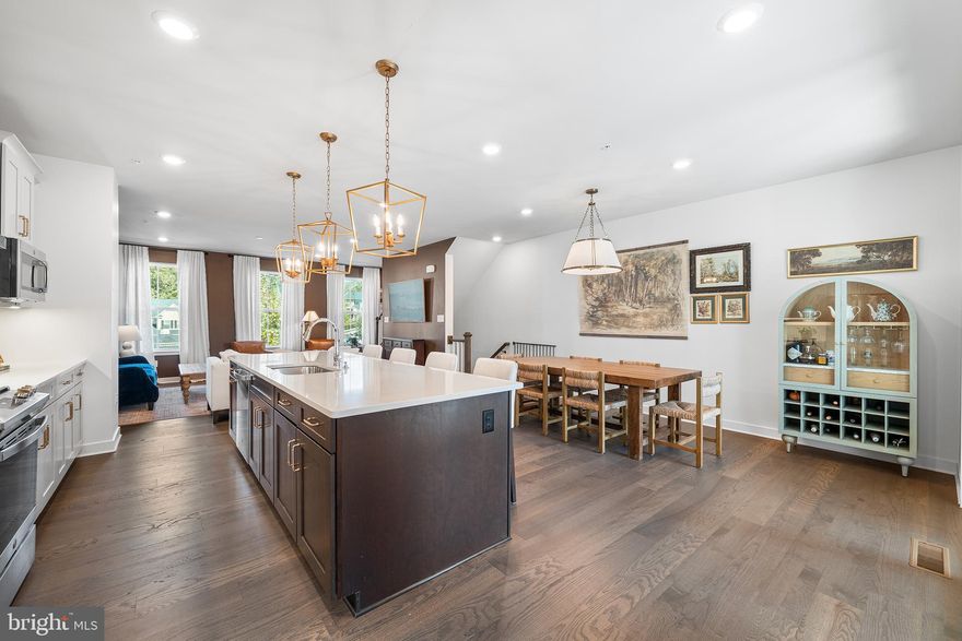 Nestled in the sought-after Ponds Edge community just four miles from vibrant downtown Media, this nearly new stone-front townhome perfectly blends sophisticated design with the practical, open-concept spaces today’s buyers crave. The entry level features a bright home office with French doors, ideal for remote work, and a dedicated mudroom with a built-in bench for seamless organization. The heart of the home is a gourmet kitchen equipped with quartz countertops, an oversized island with seating, and a gleaming tile backsplash that flows effortlessly into the spacious great room. Step through glass sliders to a private, covered porch, a true outdoor sanctuary featuring a cozy stone-accent gas fireplace and space for a TV, perfect for year-round gatherings. Upstairs, the expansive primary suite offers a tray ceiling and a spa-like ensuite with a double shower, while two secondary bedrooms share a full hall bath and a convenient laundry closet. This move-in ready gem offers a turnkey lifestyle with community sidewalks leading to playgrounds, a fitness center, and a clubhouse. Located within the award-winning Rose Tree Media School District and just minutes from the newer Wawa, SEPTA station, and downtown Media’s famous festivals and dining, this home combines upscale comfort with unrivaled convenience.