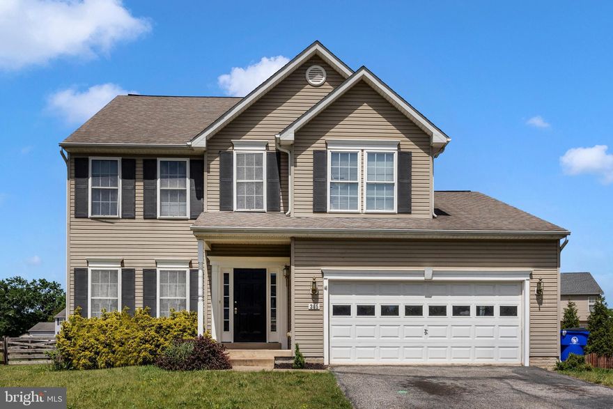 Welcome to 305 Mountaineers Way — a nicely appointed former model home and thoughtfully designed living spaces throughout! From the moment you step inside, the impressive two-story foyer sets the tone, offering a bright and welcoming entrance. The main level features a versatile layout with a formal living room and dining room, both enhanced by newer carpeting, while hardwood floors flow seamlessly through the hallway, kitchen, family room, and sunroom. The heart of the home is the kitchen, complete with stainless steel appliances, a center island, and a stylish backsplash, all opening to the family room with a cozy gas fireplace—perfect for everyday living and entertaining alike. Just off the kitchen, the sunroom/breakfast area is filled with natural light from an abundance of windows, creating a cheerful space to start your day. A convenient main-level laundry room with cabinets and a utility sink adds both function and ease. Upstairs, you’ll find four spacious bedrooms, including a  primary suite with a walk-in closet and private ensuite bath. Three additional bedrooms and a full hall bath provide plenty of space for family or guests. The finished lower level offers even more room to spread out, featuring a huge recreation room, a fifth bedroom, and a half bath—ideal for guests, hobbies, or a home office setup and a large storage area. Step outside to enjoy the rear deck overlooking the backyard.  Additional highlights include a two-car garage and the added value of being a former model home with numerous upgrades throughout. Ideally located close to the library, community pool, schools, shopping, and with easy access to U.S. Route 15, this home combines comfort, convenience, and style in one package. Don’t miss the opportunity to make this special home your own!