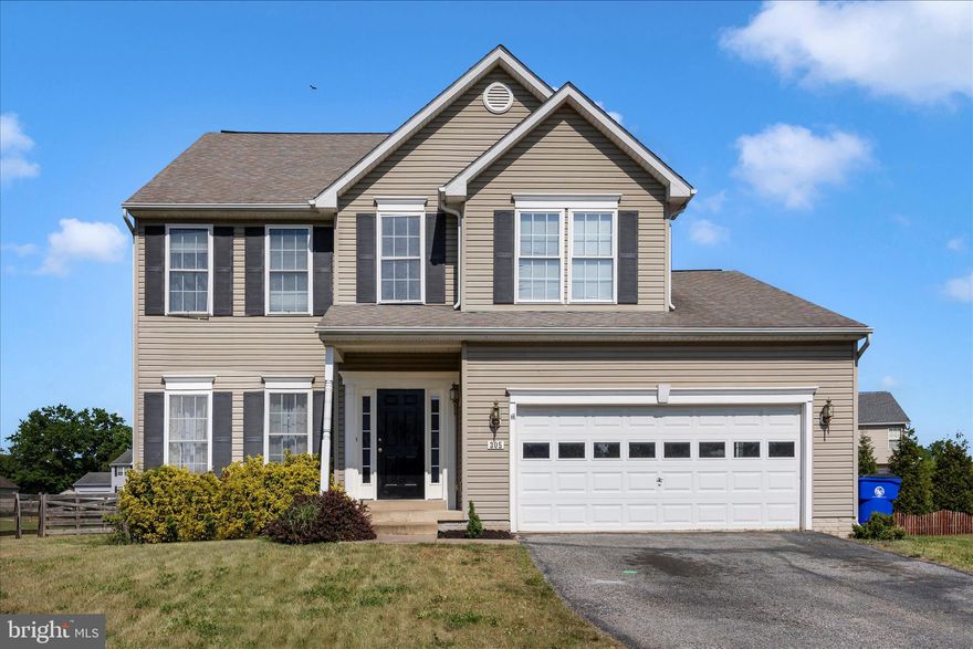 Welcome to 305 Mountaineers Way — a nicely appointed former model home and thoughtfully designed living spaces throughout! From the moment you step inside, the impressive two-story foyer sets the tone, offering a bright and welcoming entrance. The main level features a versatile layout with a formal living room and dining room, both enhanced by newer carpeting, while hardwood floors flow seamlessly through the hallway, kitchen, family room, and sunroom. The heart of the home is the kitchen, complete with stainless steel appliances, a center island, and a stylish backsplash, all opening to the family room with a cozy gas fireplace—perfect for everyday living and entertaining alike. Just off the kitchen, the sunroom/breakfast area is filled with natural light from an abundance of windows, creating a cheerful space to start your day. A convenient main-level laundry room with cabinets and a utility sink adds both function and ease. Upstairs, you’ll find four spacious bedrooms, including a  primary suite with a walk-in closet and private ensuite bath. Three additional bedrooms and a full hall bath provide plenty of space for family or guests. The finished lower level offers even more room to spread out, featuring a huge recreation room, a fifth bedroom, and a half bath—ideal for guests, hobbies, or a home office setup and a large storage area. Step outside to enjoy the rear deck overlooking the backyard.  Additional highlights include a two-car garage and the added value of being a former model home with numerous upgrades throughout. Ideally located close to the library, community pool, schools, shopping, and with easy access to U.S. Route 15, this home combines comfort, convenience, and style in one package. Don’t miss the opportunity to make this special home your own!