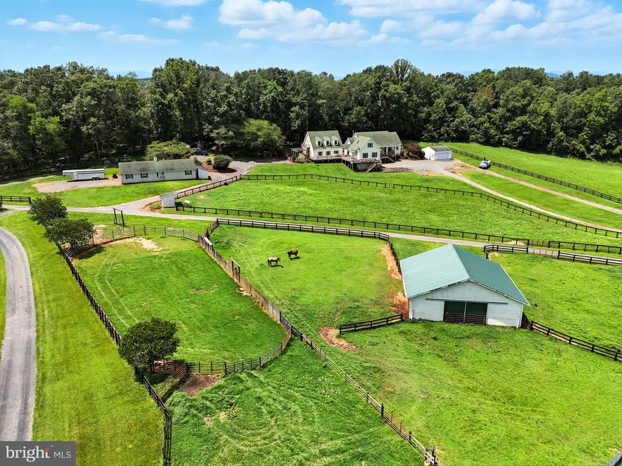 A Truly Rare and Incredible Equestrian Property!  Nestled on an expansive 11-acre lot, this property is unique in that it boasts two homes….a 4 bedroom/3 bath Rambler and 3 bedroom/2.5 bath Cape Cod, with a shared breezeway and wrap around deck!  Whether you are looking for a multi-generational property or need space to house equine trainers, guests, etc, this property is for you!
Built in 2004, the homes offer a combined 4,500 sq/ft of living space, featuring a total of 7 bedrooms and 6.5 bathrooms.  Each home offers kitchens, dining and living rooms, as well as, main level primary bedrooms.  A perfect blend of comfort and functionality that is ideal for those with equestrian-oriented endeavors, or a tranquil retreat.  The property offers two large barns – one with 6 stalls, wash stall and tack room, and the other with attached run-ins and tons of storage. Arena and round pen conveniently connected.  Freshly painted fencing clearly defines the multiple paddocks.  Don’t miss the attached and detached garages and tons of parking. This home is not just a residence; it's a lifestyle. Experience the perfect blend of comfort, space, and outdoor adventure in a setting that feels like a private sanctuary.  Be sure to check out the features list for more details about each home and all this property has to offer!