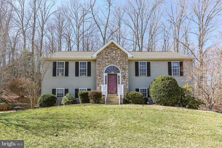 A classic beauty located just minutes from the VRE, shopping and so much more? Oh yes, it’s time to check out 9508 Timberlake Road! This residence includes four bedrooms (one NTC), three baths and more than 2,500 square feet of living space. It sits on a nearly one-acre lot in the Timberlake community in Spotsylvania County – the community has two parks for residents to enjoy! Let’s not beat around the bush and get straight to the location. The Spotsylvania VRE station is less than 5 minutes east; Spotsylvania Regional Medical Center and the endless shopping, dining and grocery options within Cosner’s Corner are less than 10 minutes west; and I-95 access (Massaponax exit) is less than 10 minutes northwest. The heart of Downtown Fredericksburg is within 15 minutes north! Zooming in on the lot here, the front yard is super-low-maintenance, with lots of shrubbery donning its frontside. An asphalt driveway segues to the home’s side-loading, two-car garage (with epoxy flooring!) on the lower level. The back yard – in the words of its current owner – is “pure magic!” Thick forest abounds behind its back property line, where it’s common to see bunnies, squirrels and even turtles scurrying about. Anchoring the back yard space is a two-tiered, recently resealed deck. Off one side of the home, note the patio and firepit area. The home itself has cream siding, a stone-accented front facade, black shutters and a burgundy front door. The roof is one year old! Heading inside, it’s split-level bliss as laminate hardwood floors, and soaring vaulted ceilings abound! Upstairs and on the main level, you arrive in the living room with vistas straight through the back sliding glass door and into the lush woods. Also in the communal area are the dining room and the kitchen – the kitchen includes newer white/gray laminate flooring, a breakfast bar, medium brown cabinets, window box seating overlooking the back yard, neutral counters and stainless-steel appliances. Off the living room, you’ll find the primary suite, with carpeted flooring, two walk-in closets and an ensuite bath with a green tile-surrounded jacuzzi tub, stand-up shower and dual sinks. Off the kitchen and dining room, you’ll find the additional two, carpeted bedrooms. Between them is a full bath with a tub/shower combo and single sink. Heading downstairs, you’ll find a lower-level family room with lovely built-ins. Additional highlights include the home’s final bedroom (NTC), a full bath (tub/shower combo and single sink), and double doors to that stellar fire pit and patio area. The laundry room downstairs is perfect for storage and, core component-wise, the residence’s hot water heater was replaced just two years ago and the HVAC has been regularly maintained. A favorite of the current owner: “seeing the sun coming through the primary bedroom windows in the morning and then watching the sunset behind the forest... it’s a patch of heaven.” The dreaminess at 9508 Timberlake Road is something you need to see to believe!